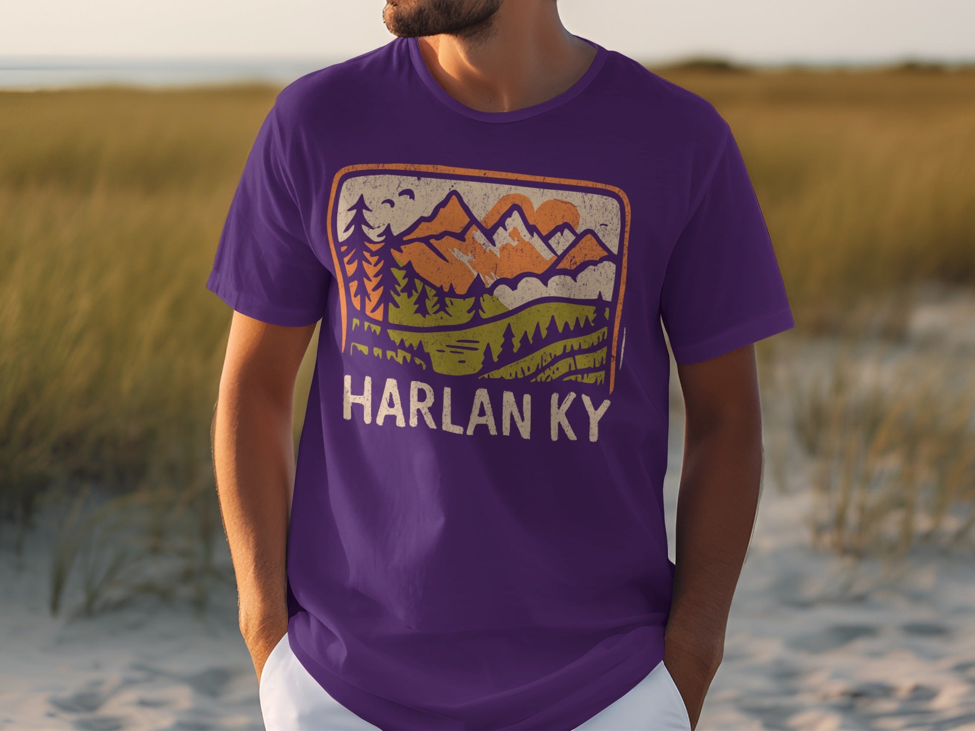Purple t-shirt with distressed mountain and forest graphic and "HARLAN KY" text