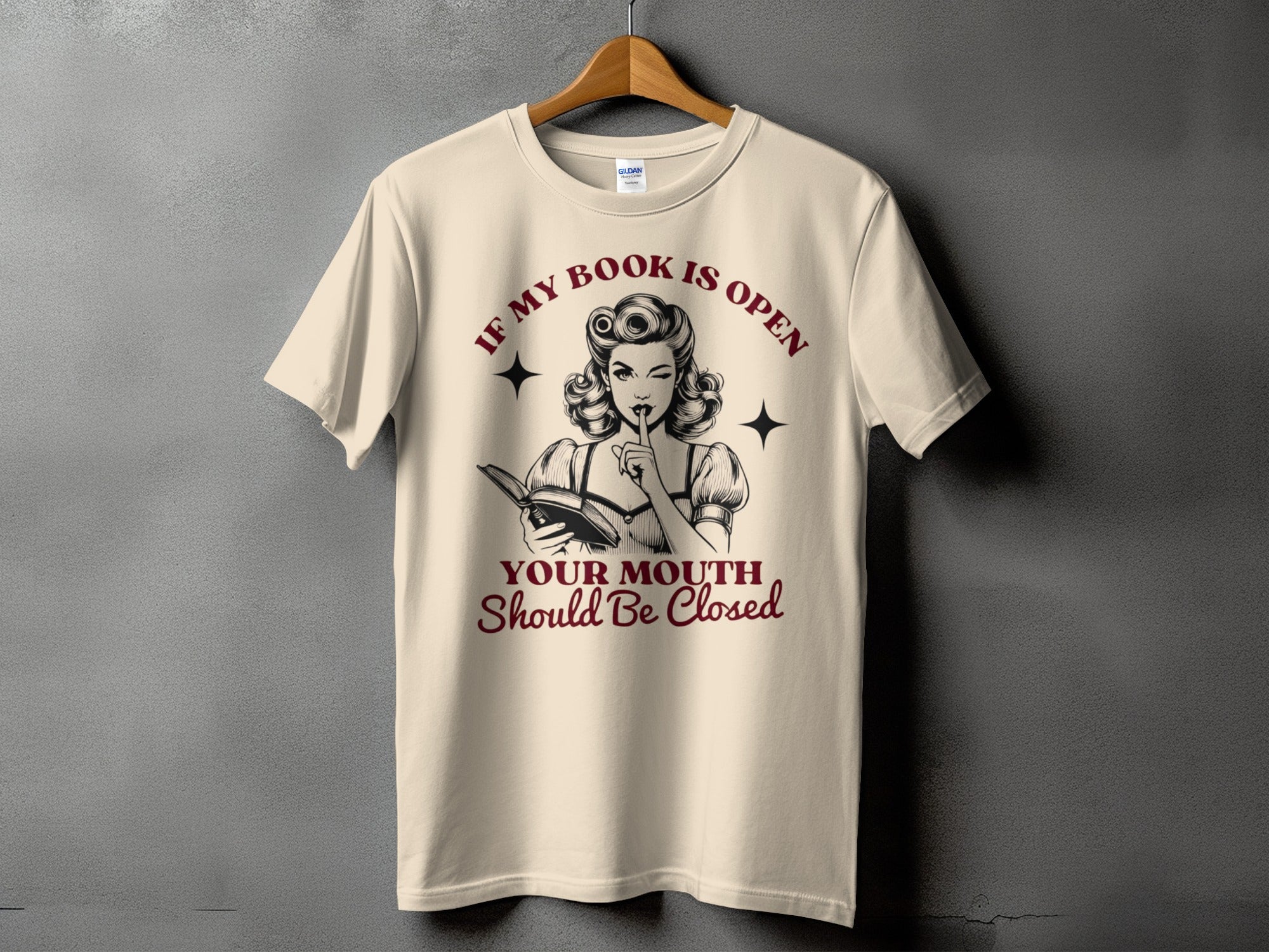 Cream t-shirt with retro graphic and text: If my book is open, your mouth should be closed.