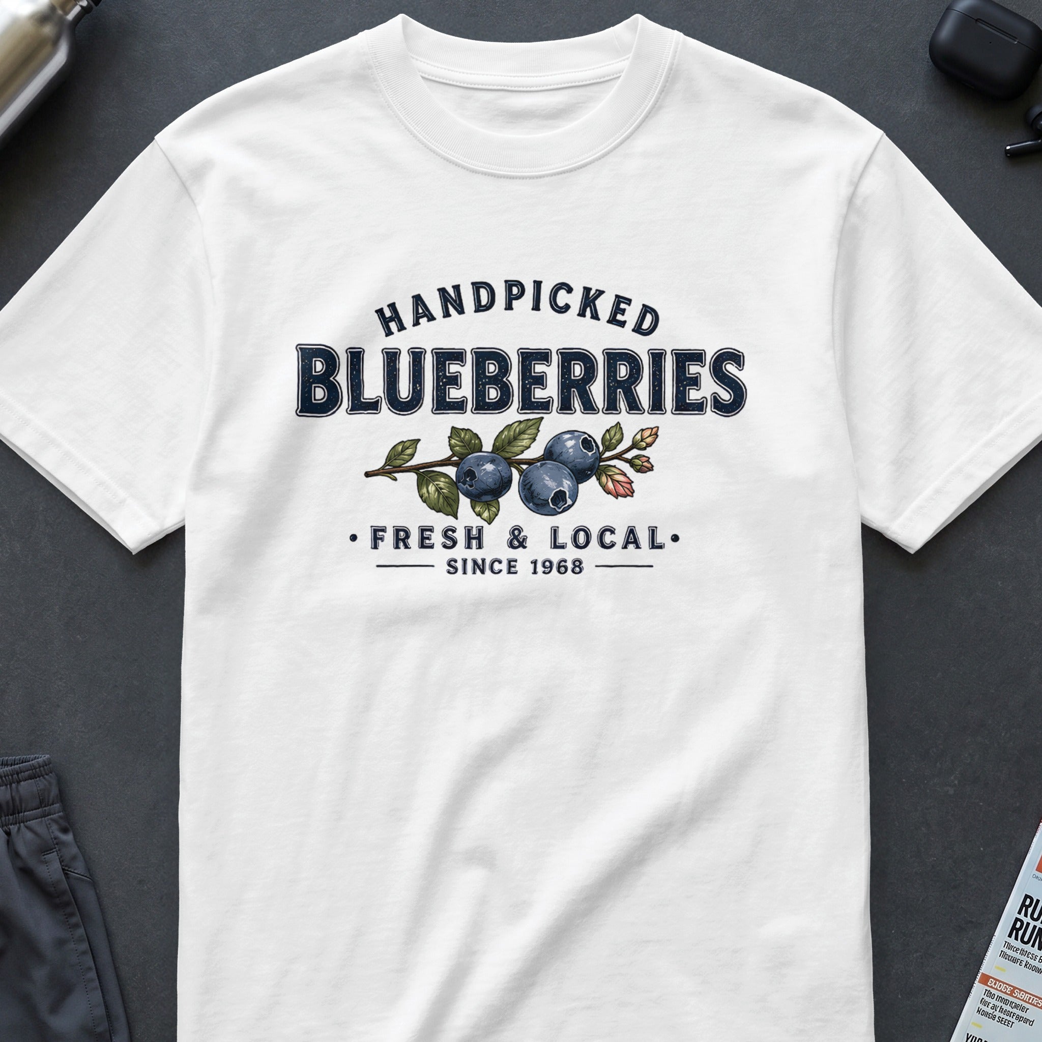 White t-shirt with "Handpicked Blueberries", "Fresh & Local", "Since 1968" graphic.
