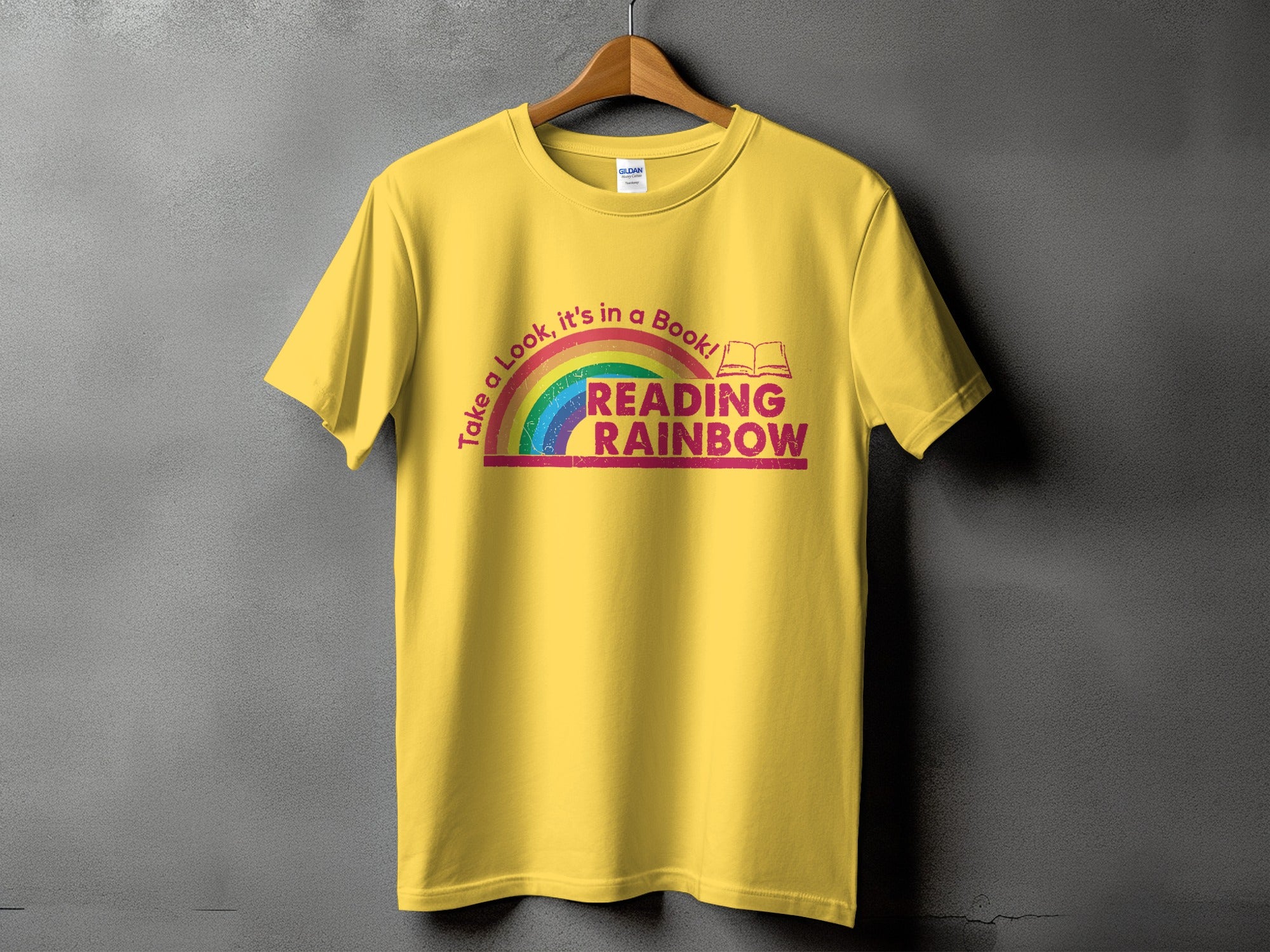 Yellow t-shirt with "Take a Look, it's in a Book! READING RAINBOW" graphic.
