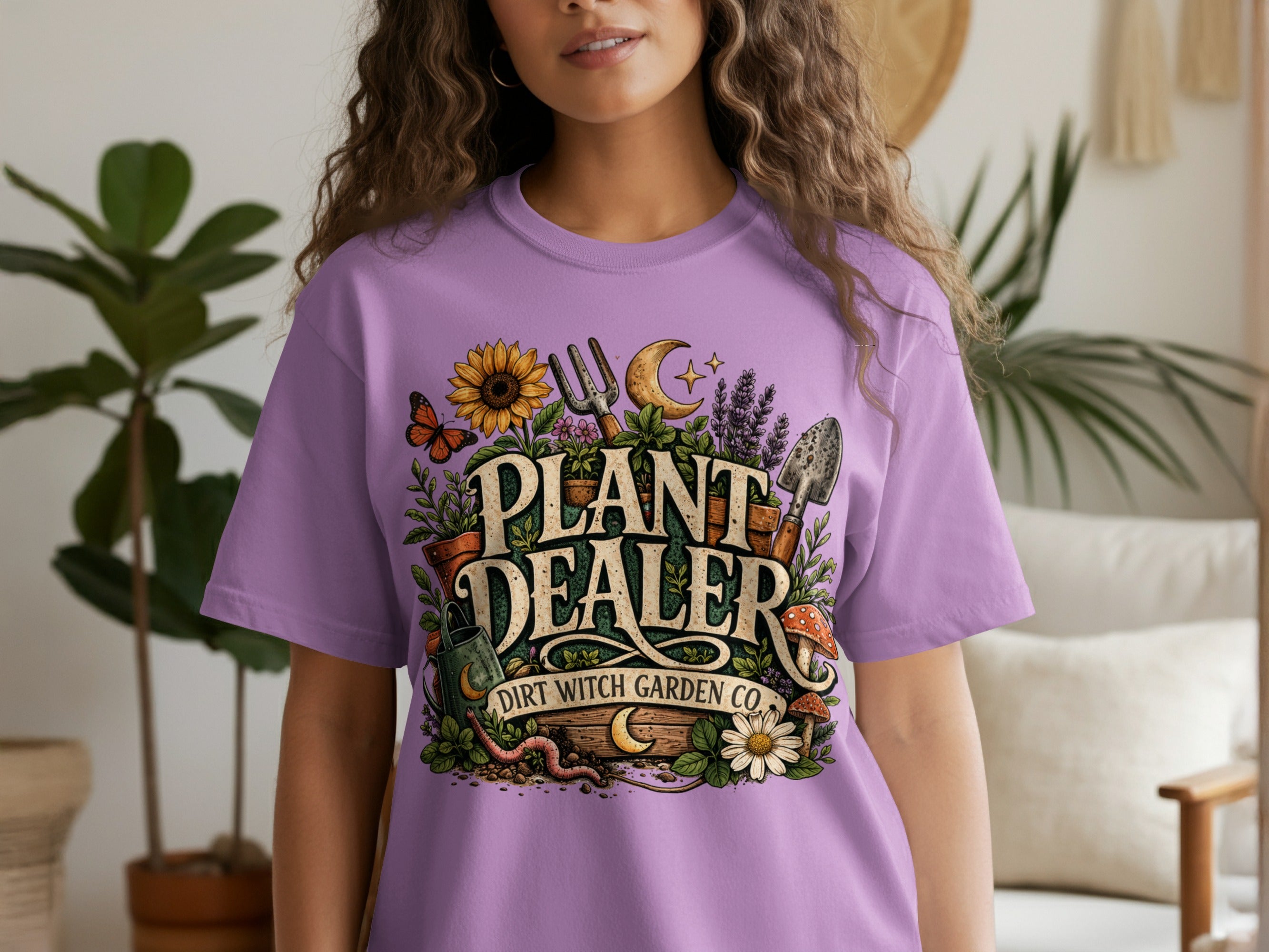Purple t-shirt with "PLANT DEALER DIRT WITCH GARDEN CO." text and gardening graphics.