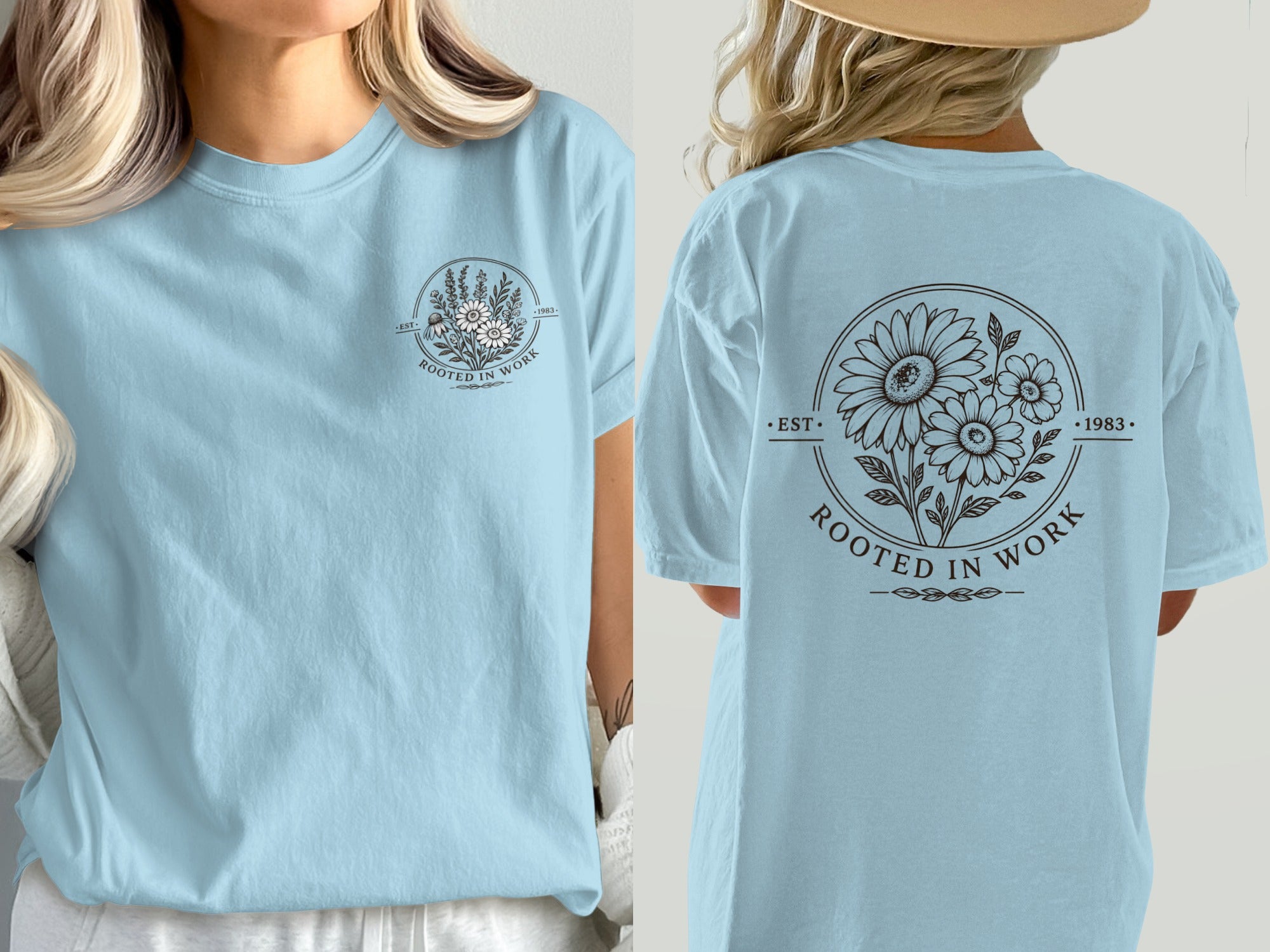 Light blue t-shirt with circular floral design and text "EST. ROOTED IN WORK 1983".