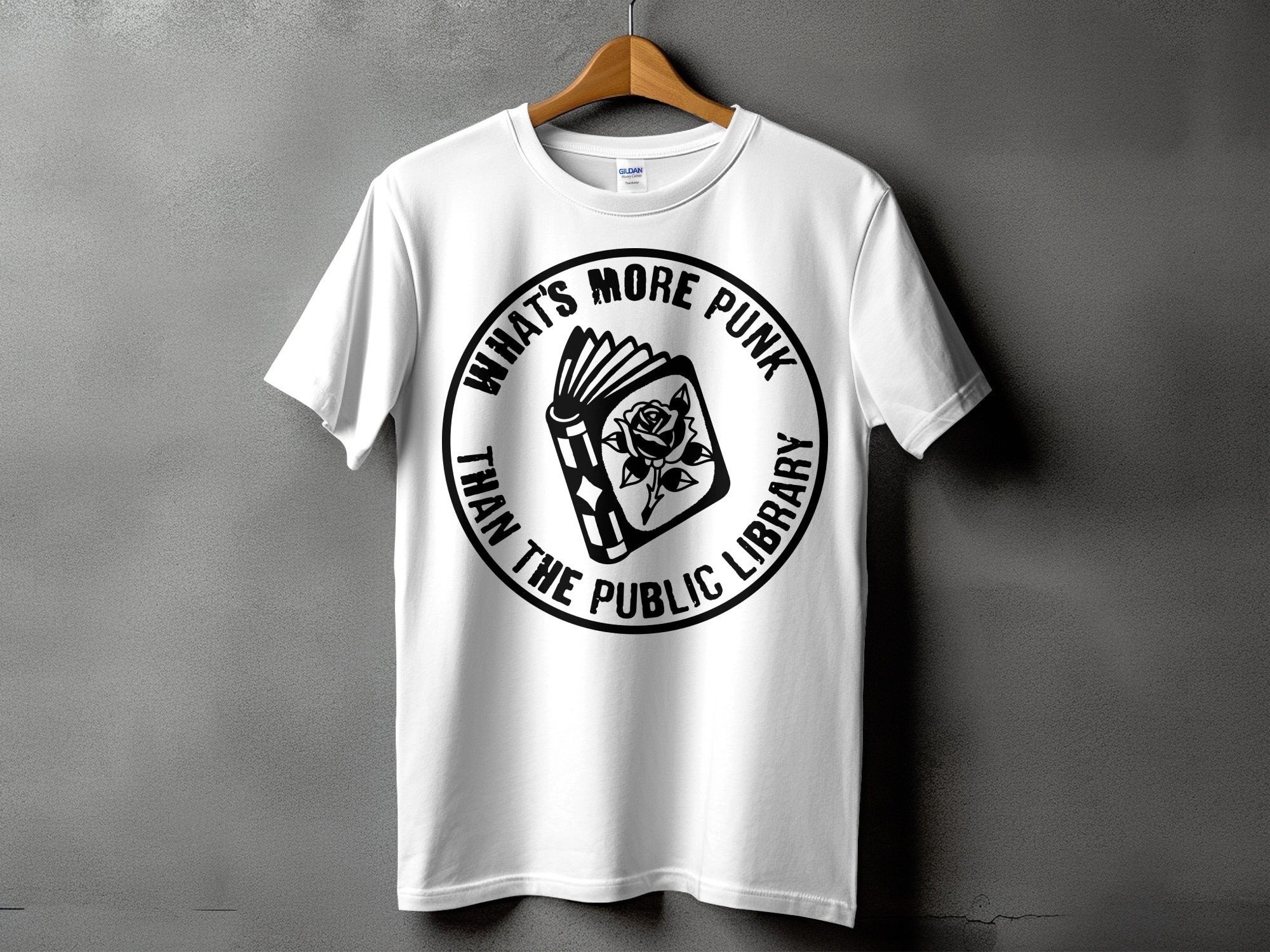White t-shirt with a black graphic of a book and rose with text "What's More Punk Than The Public Library".