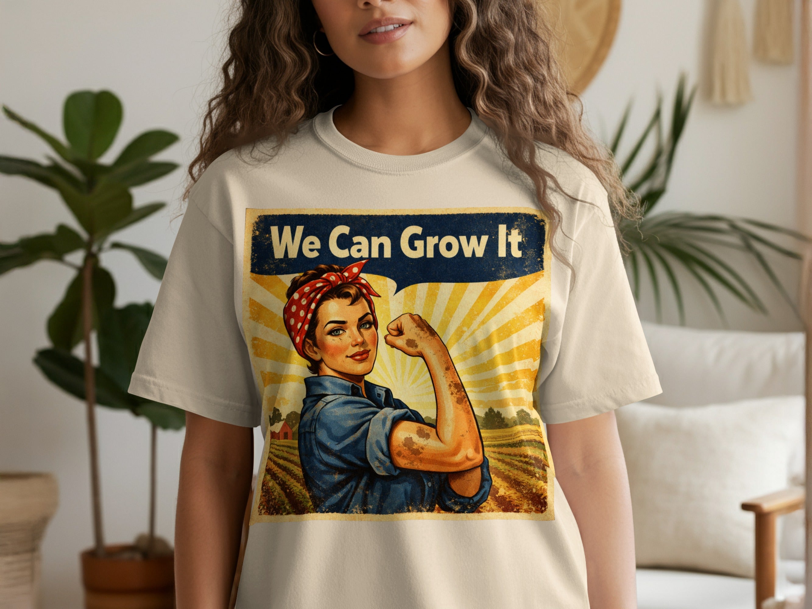 T-shirt with a vintage poster design of Rosie the Riveter flexing; text reads "We Can Grow It".