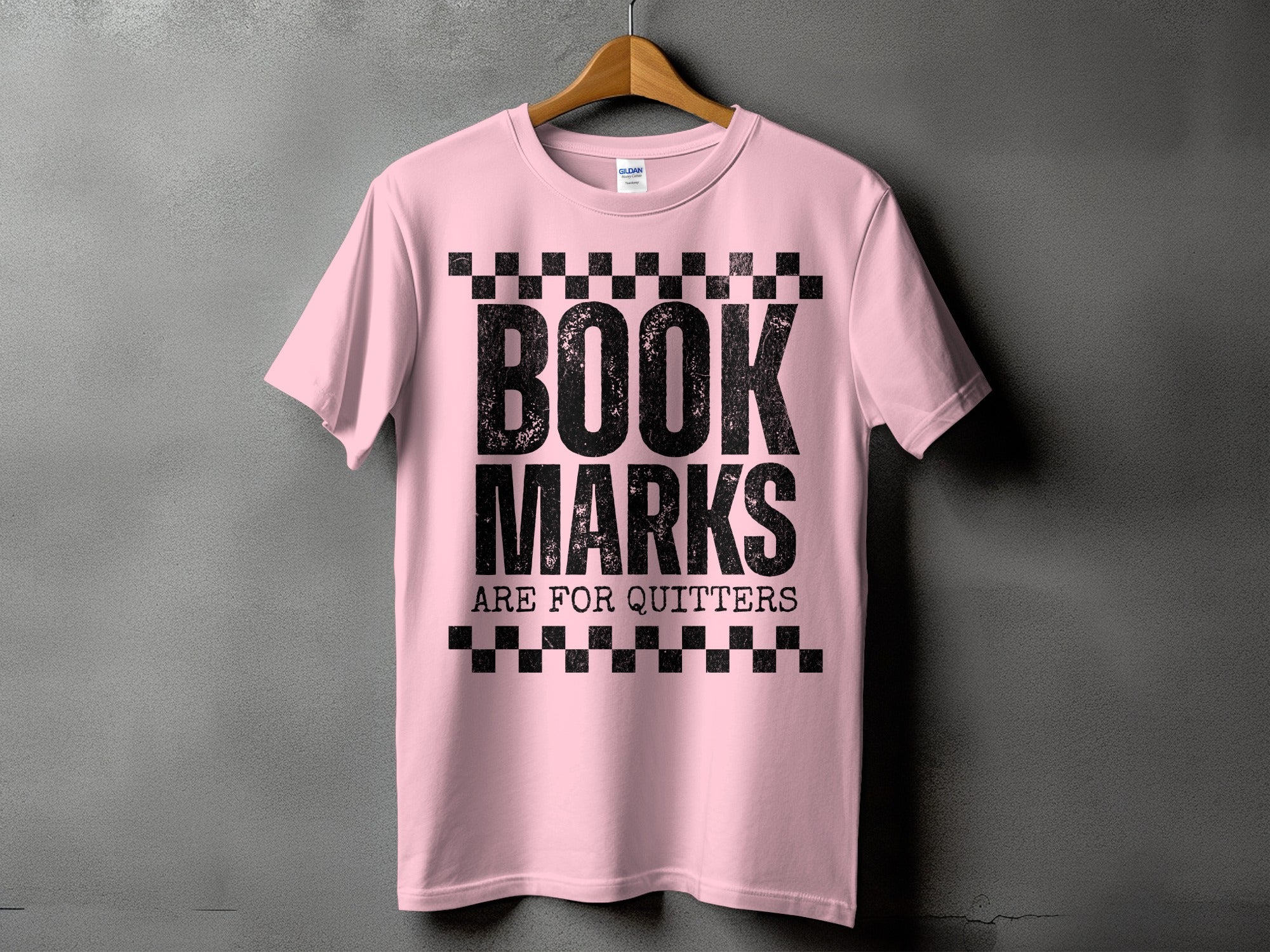 Pink t-shirt with black text "BOOK MARKS ARE FOR QUITTERS"