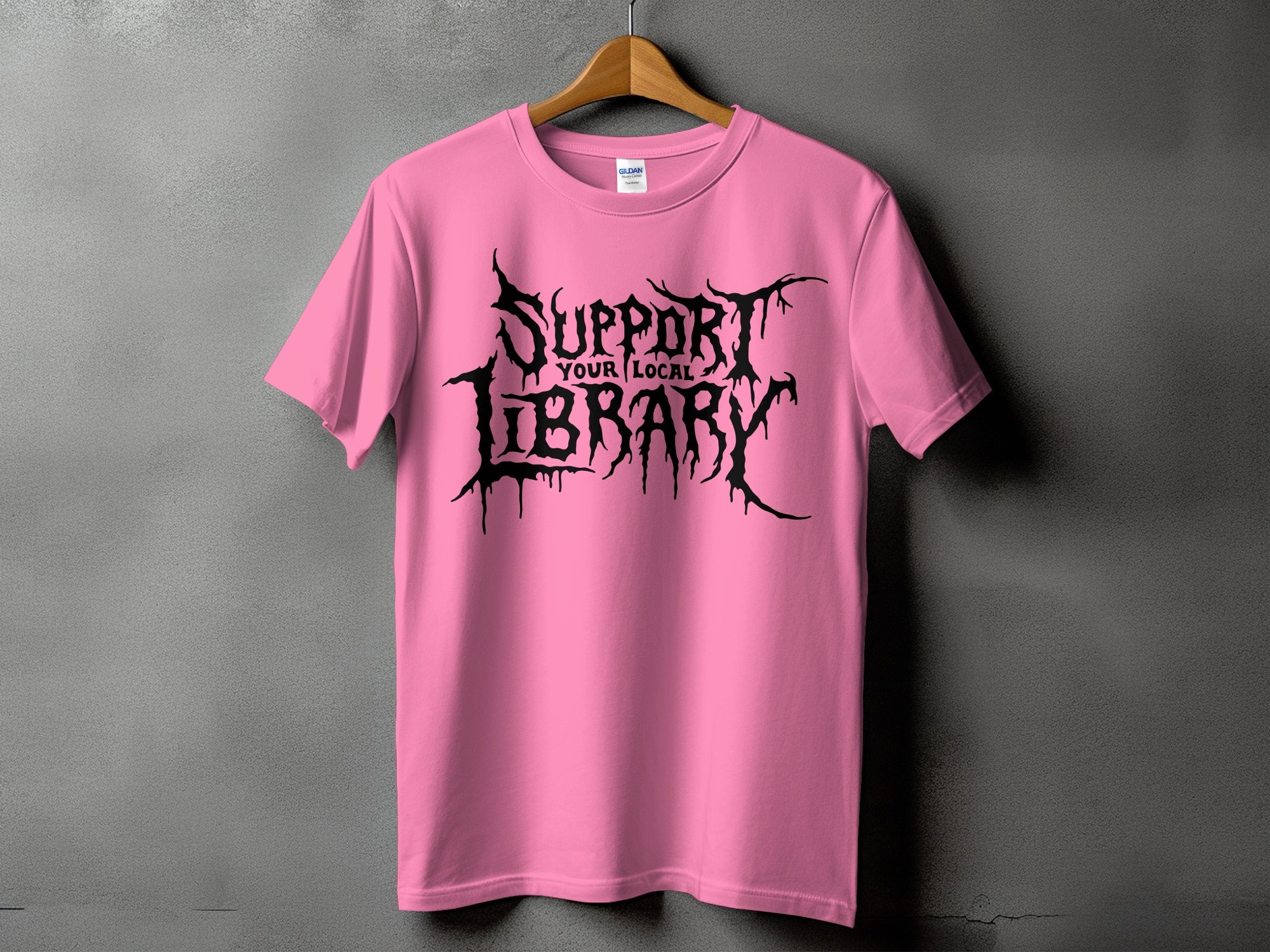 Pink t-shirt with black gothic text that reads "Support Your Local Library."