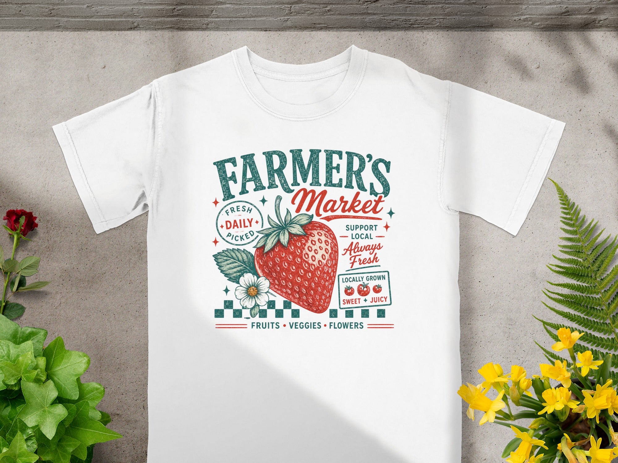 White t-shirt with "Farmer's Market" graphic featuring a strawberry and floral elements.