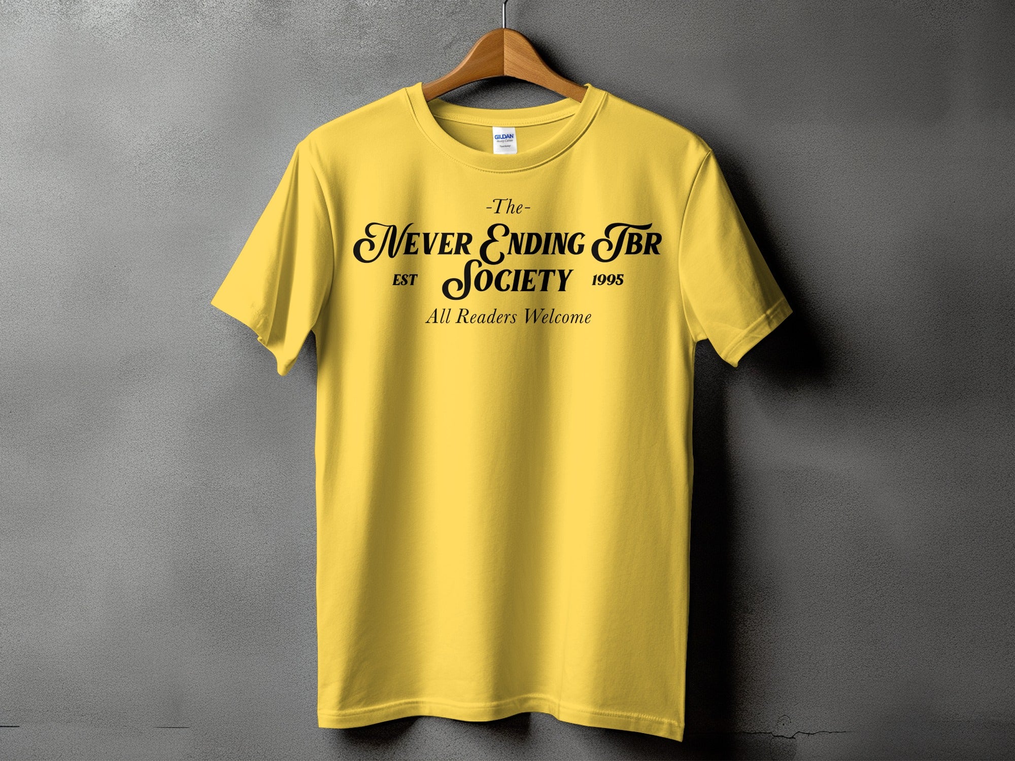 Yellow t-shirt with black text: The Never Ending TBR Society EST 1995 All Readers Welcome