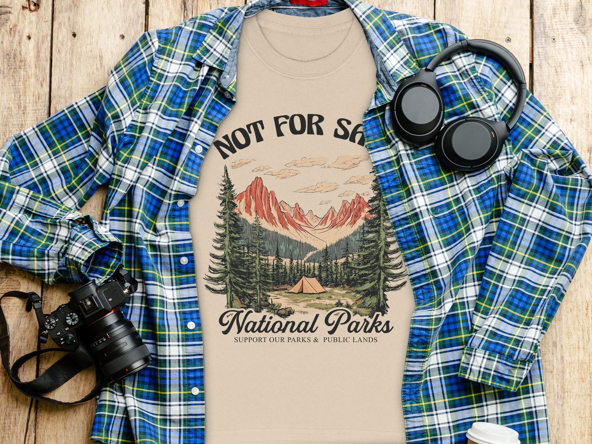 T-shirt with "National Parks" design, camping scene, mountains, and trees.