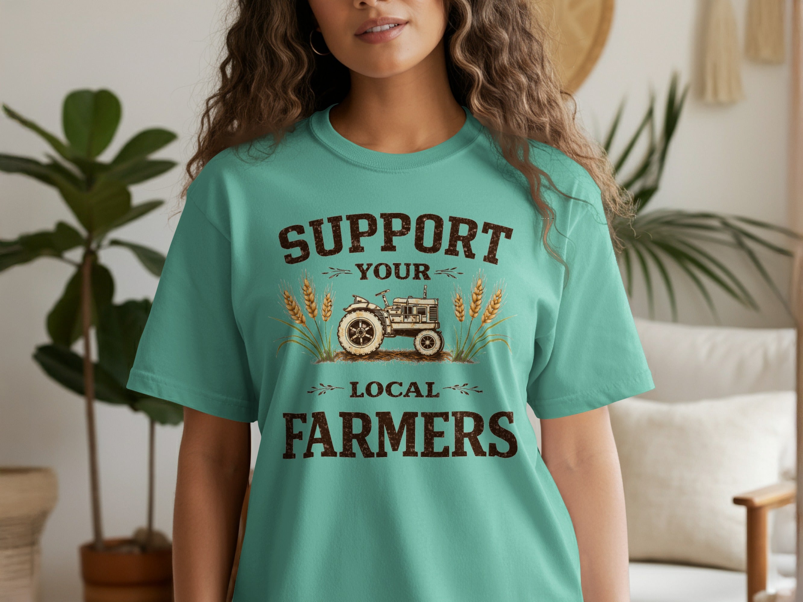 Teal t-shirt with vintage tractor graphic and text "Support Your Local Farmers".