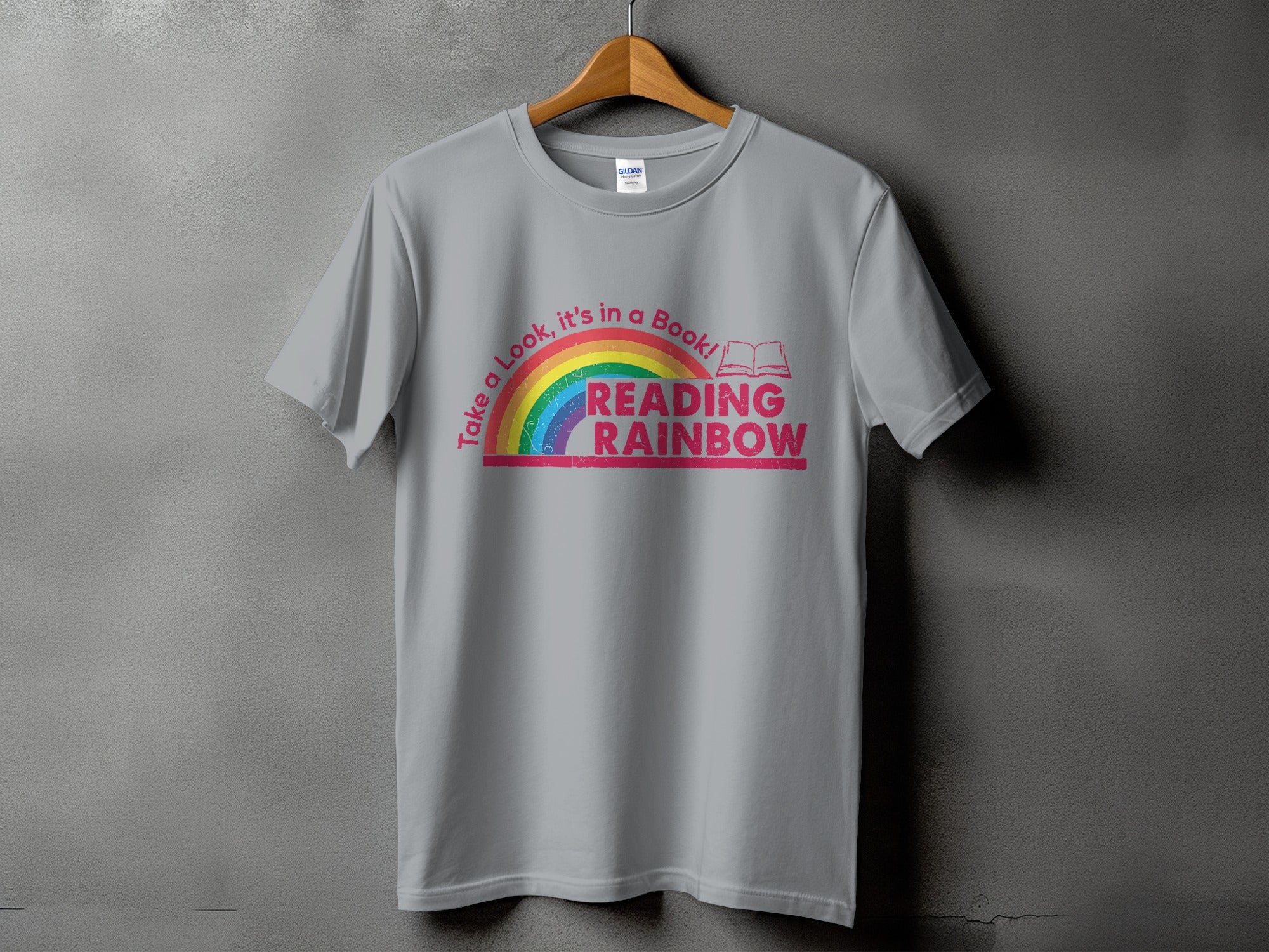 Grey t-shirt with "Take a Look, it's in a Book! READING RAINBOW" text and rainbow graphic.
