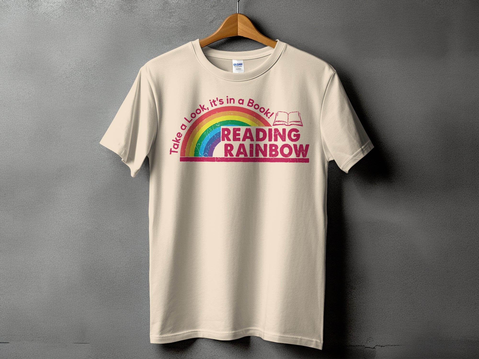 Light cream t-shirt with "Take a Look, it's in a Book! READING RAINBOW" text.