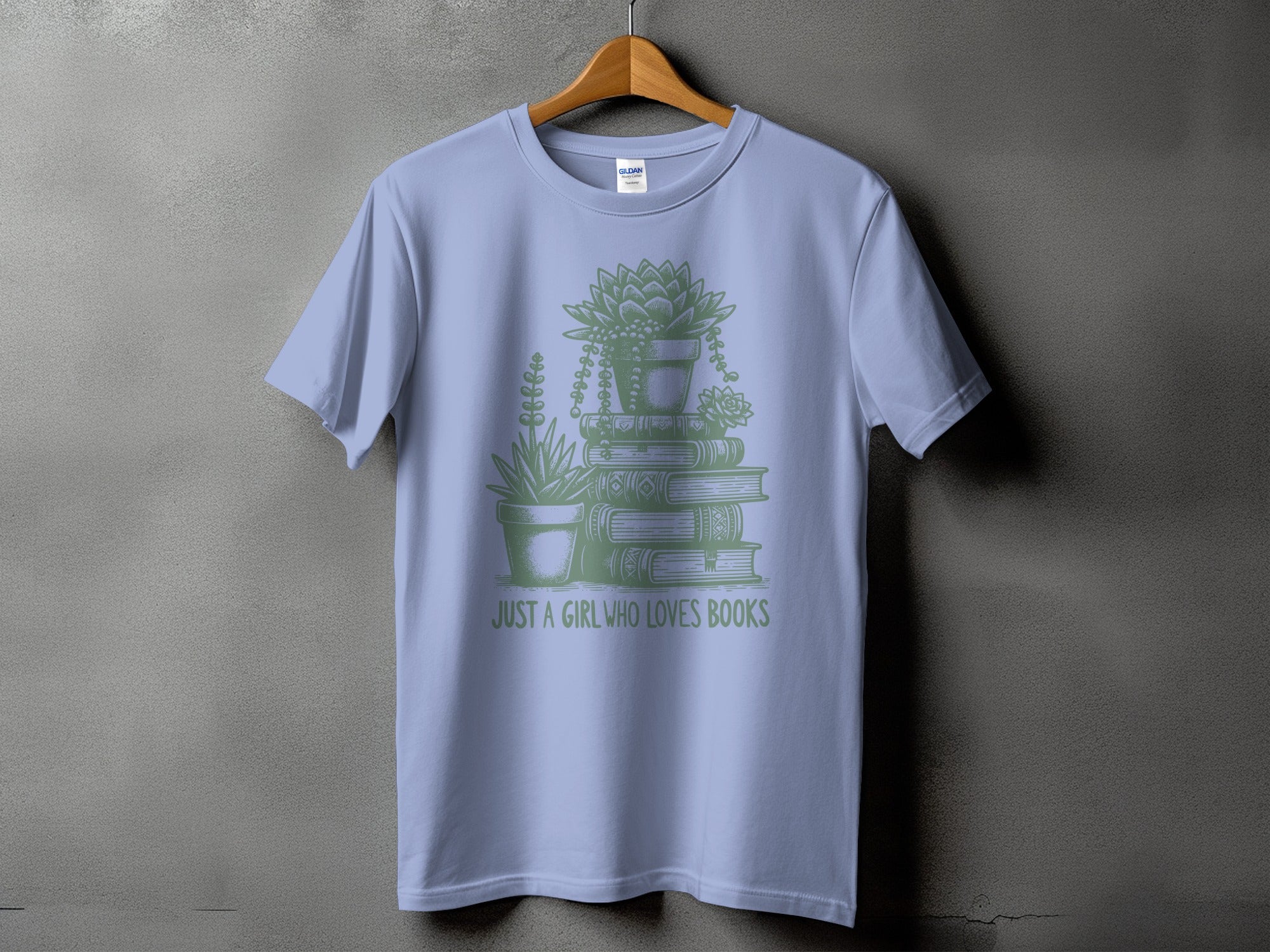 Light blue t-shirt featuring a stack of books and potted succulents with "JUST A GIRL WHO LOVES BOOKS" text.