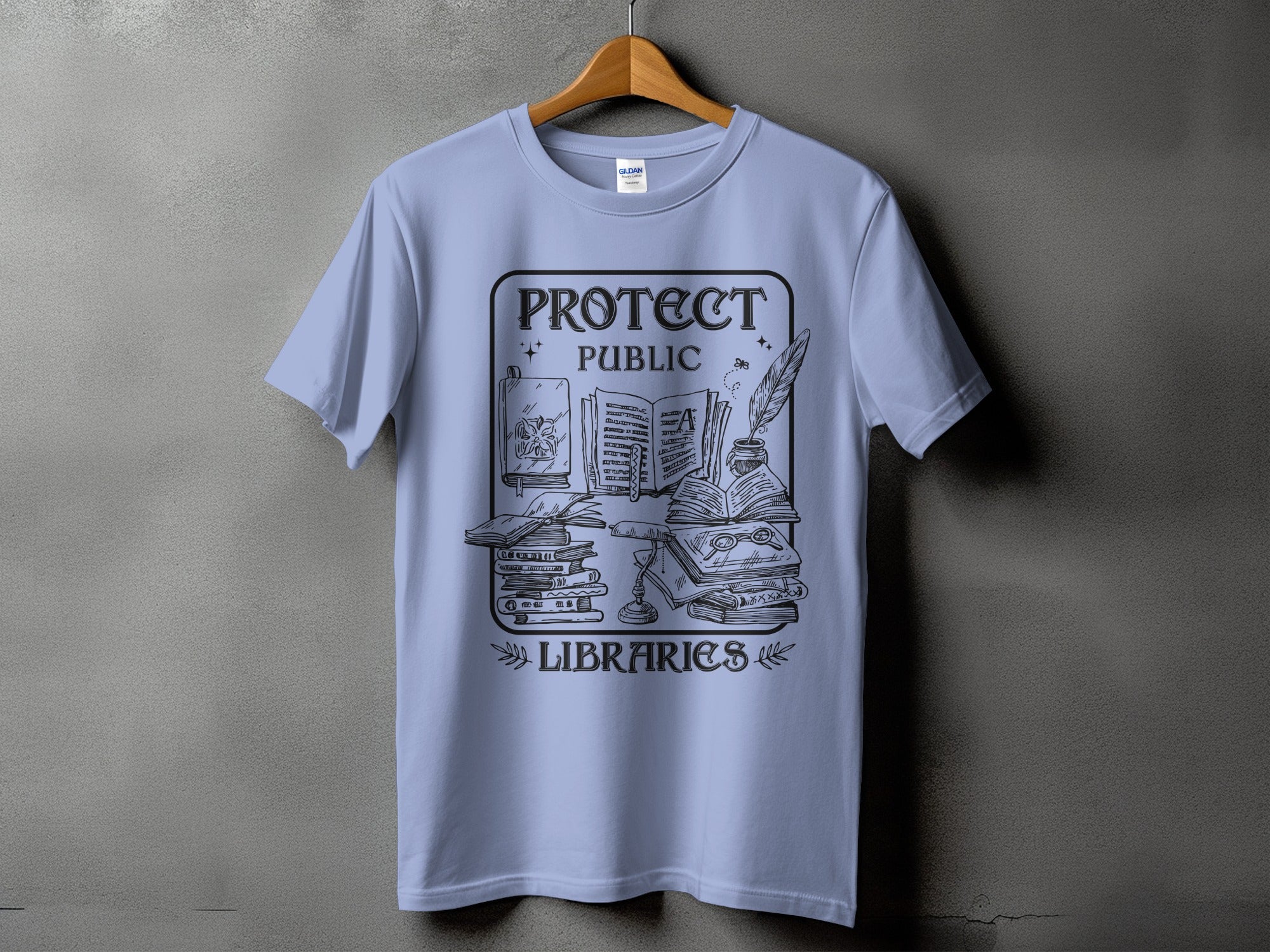 Shirt with "Protect Public Libraries" text and illustration of books, lamp, and quill.