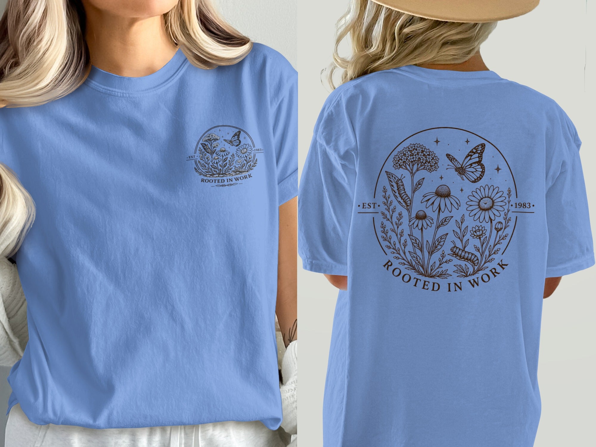 Light blue t-shirt with brown floral design, butterfly, and text "ROOTED IN WORK".