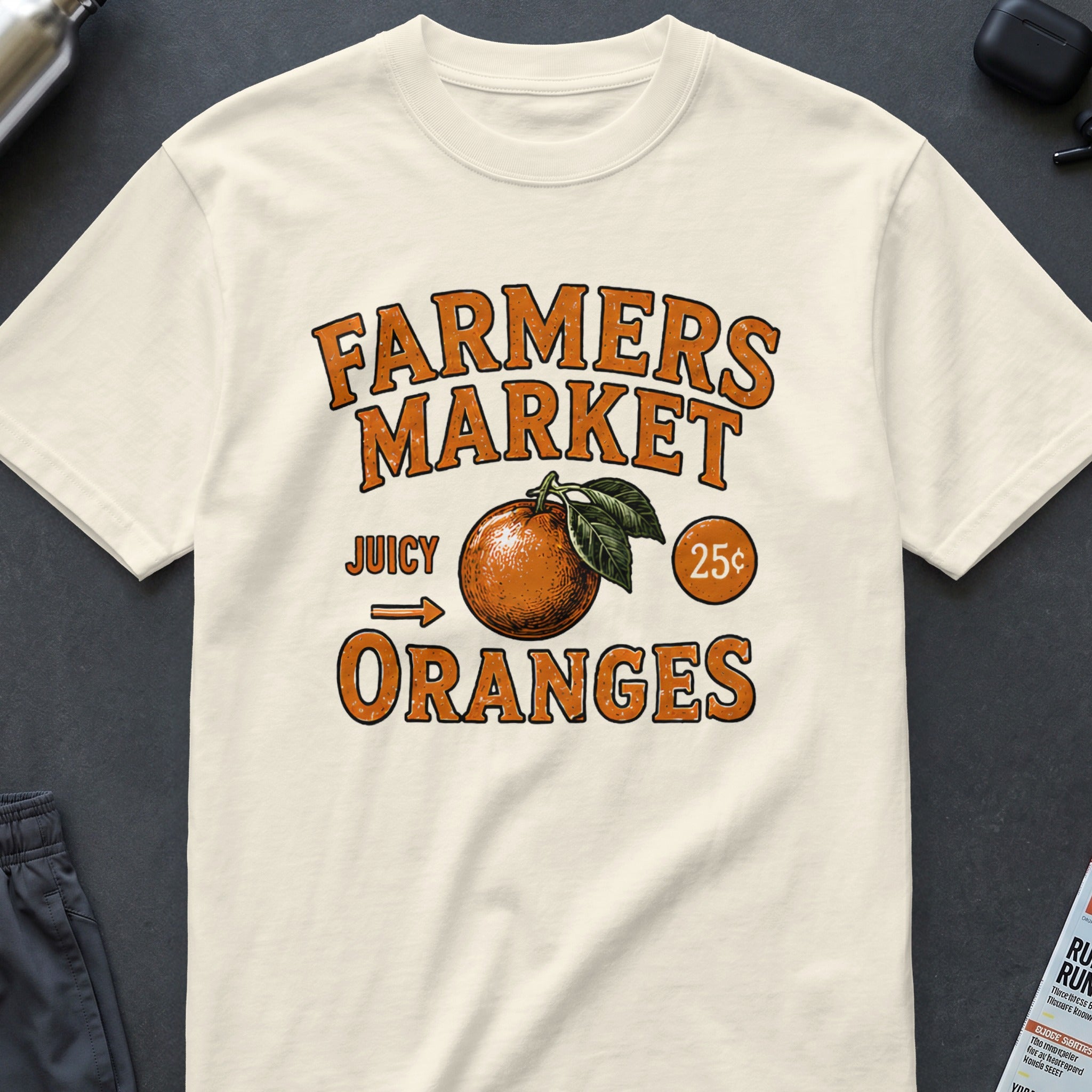 Cream t-shirt with "Farmers Market Juicy Oranges 25¢" graphic and orange illustration.