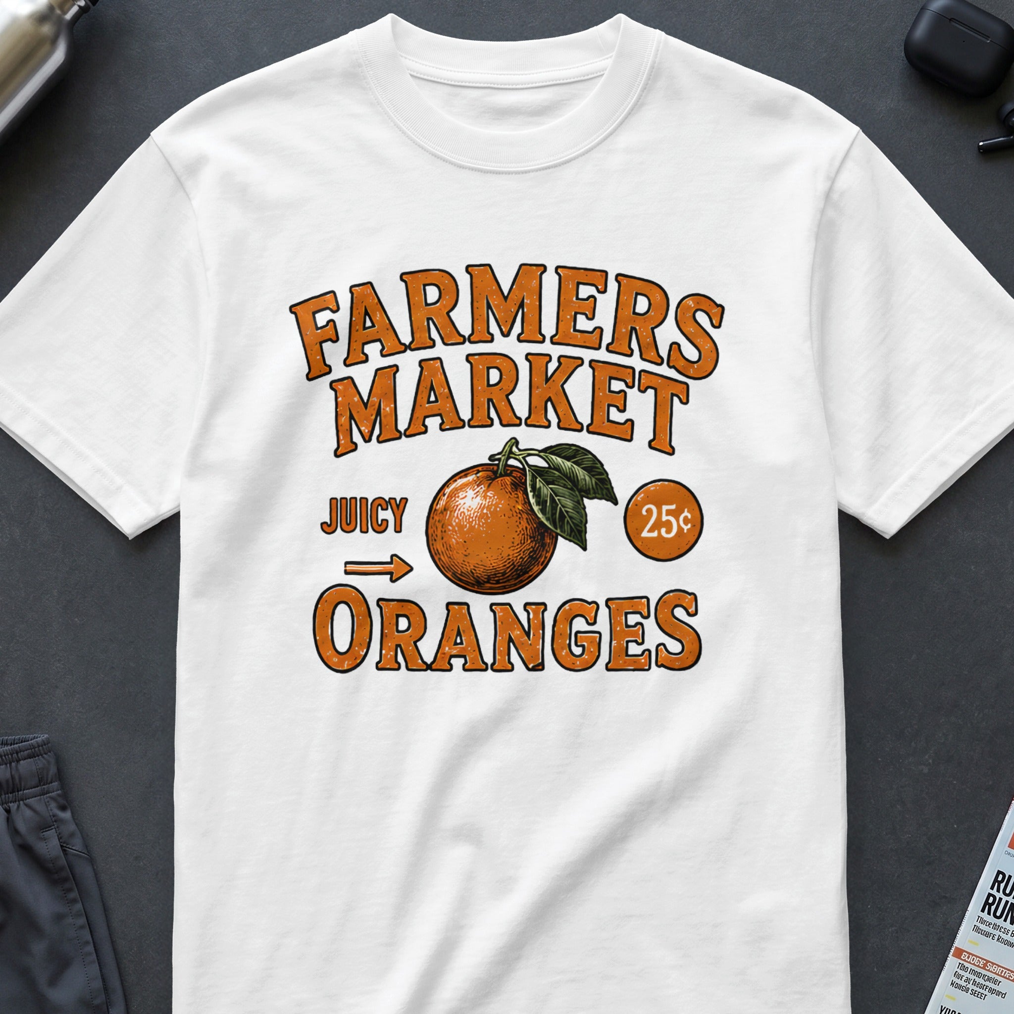 White t-shirt with "Farmers Market Juicy Oranges 25¢" graphic.