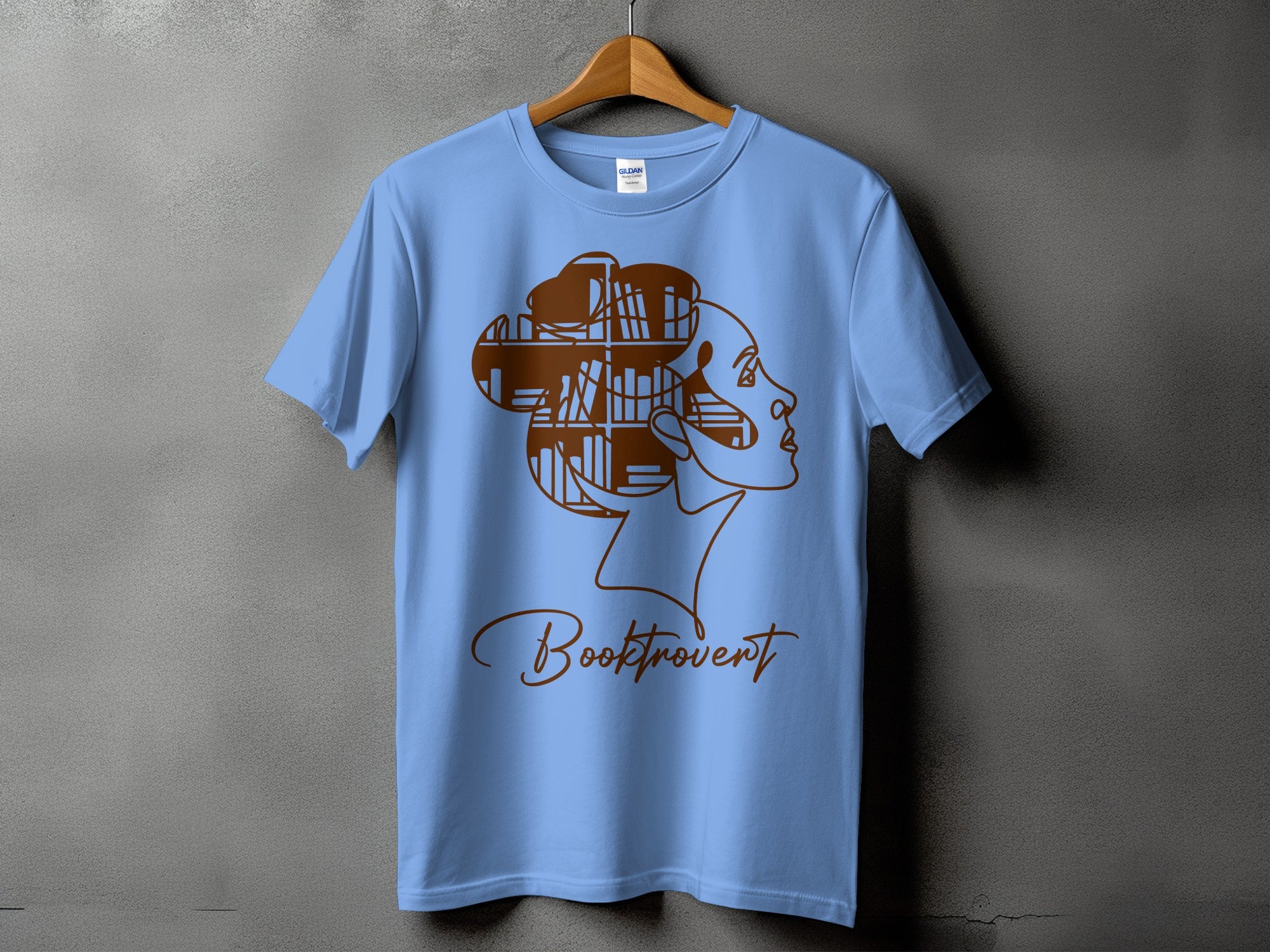 Light blue t-shirt with a minimalist line drawing of a woman's profile and the text "Booktrovert".