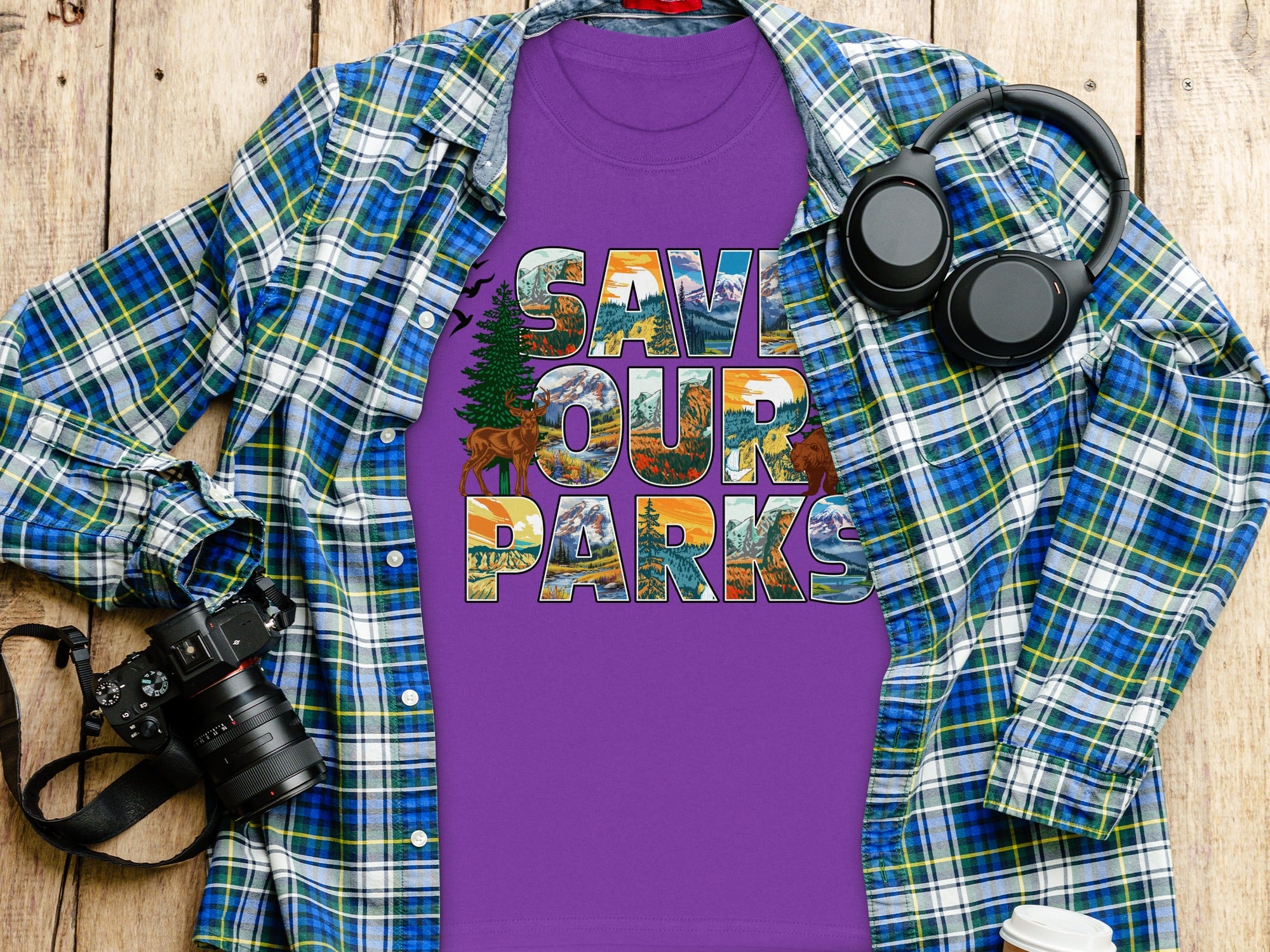 Purple t-shirt with "SAVE OUR PARKS" text featuring mountain and nature scenes.