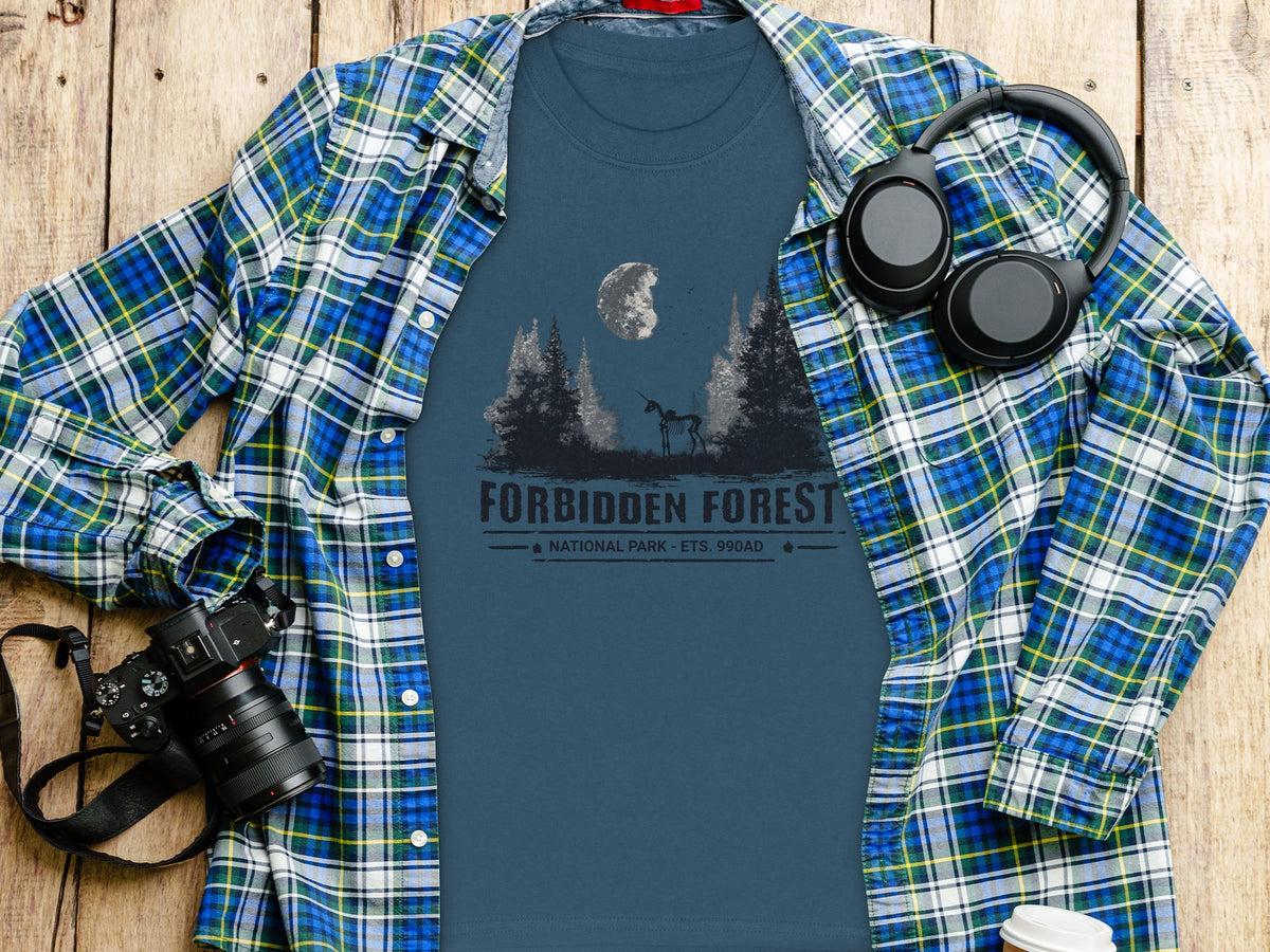 Blue t-shirt with "Forbidden Forest National Park" graphic, layered under open plaid shirt.