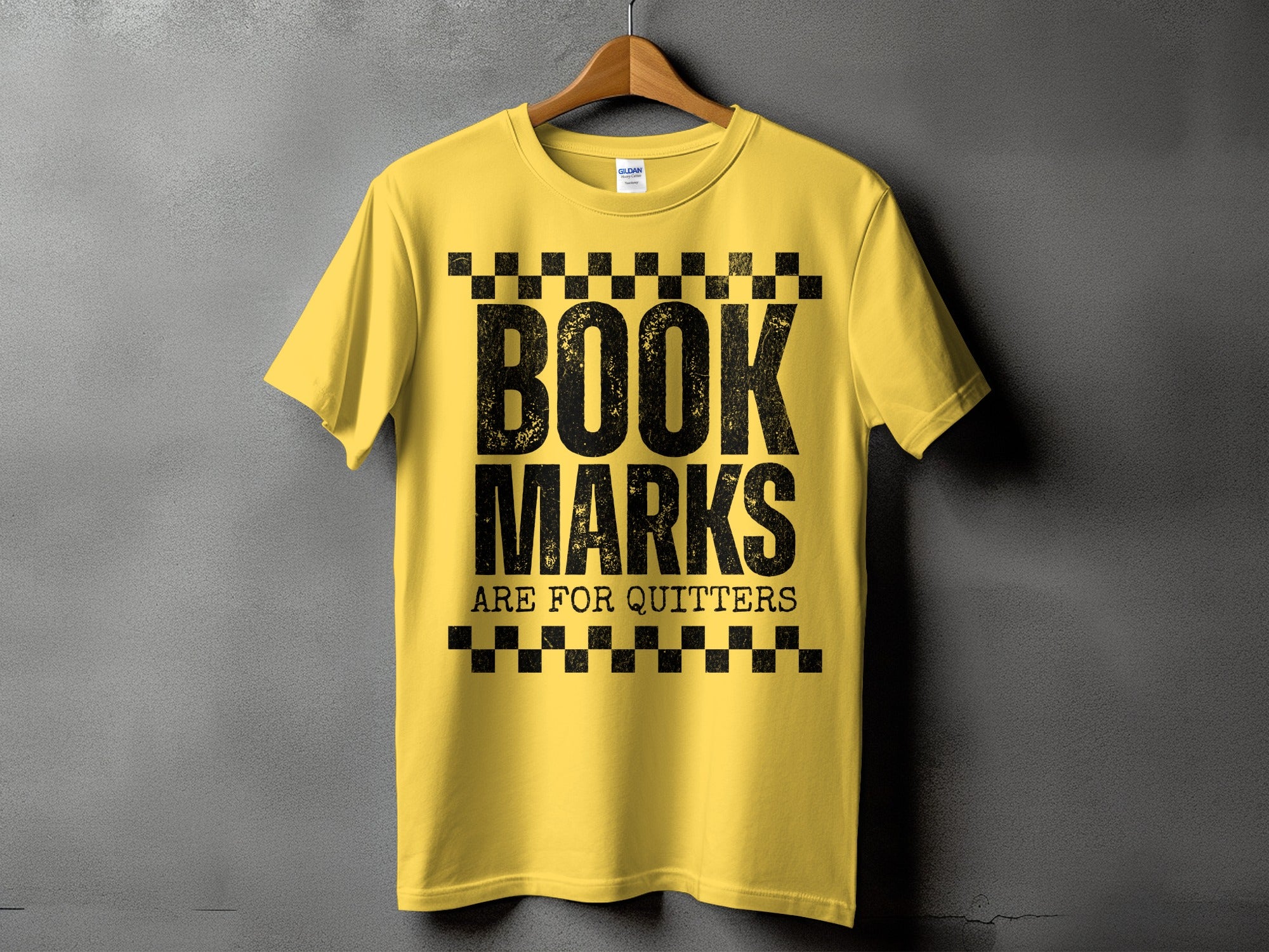 Yellow t-shirt with black text "BOOK MARKS ARE FOR QUITTERS"