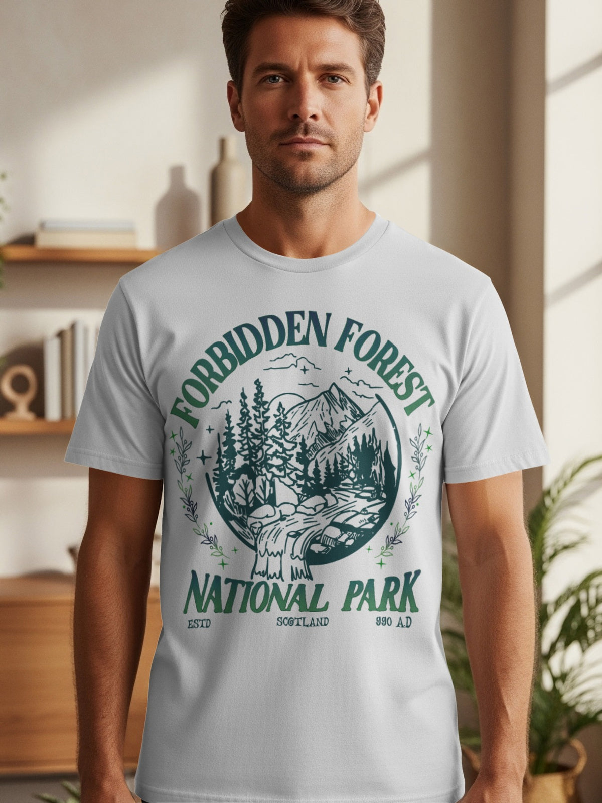 White t-shirt with "Forbidden Forest National Park Scotland 990 A.D." text and a forest scene graphic.