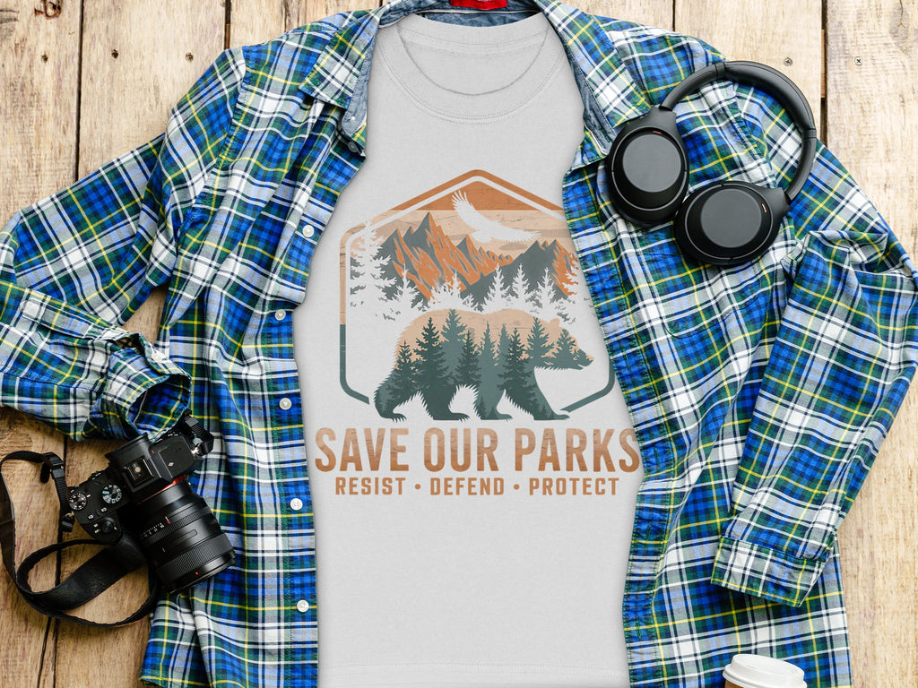 White t-shirt with "Save Our Parks Resist Defend Protect" graphic and bear.