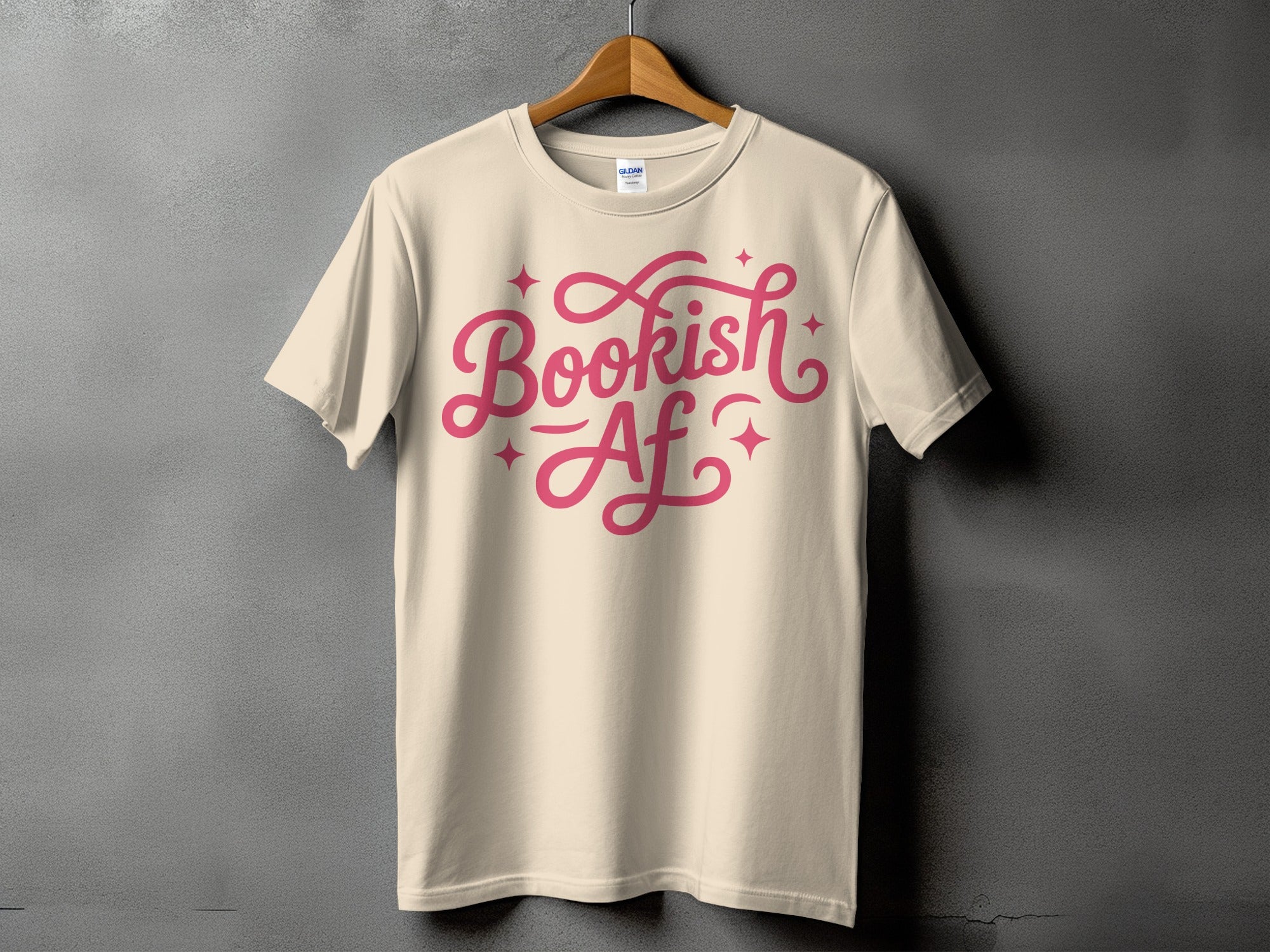Light yellow t-shirt displaying "Bookish AF" in pink script font with decorative stars.