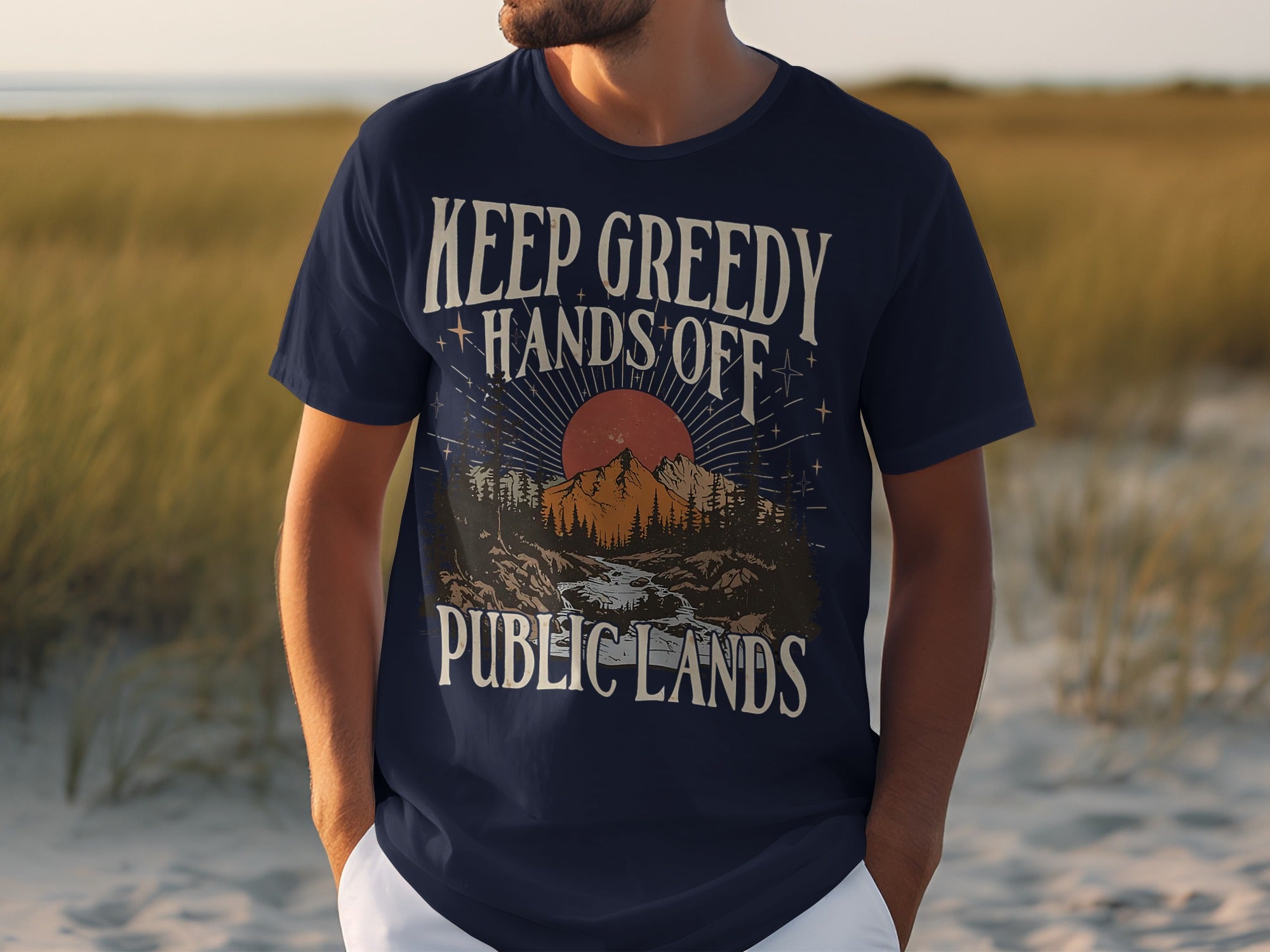 Navy t-shirt with "KEEP GREEDY HANDS OFF PUBLIC LANDS" text and nature graphic.
