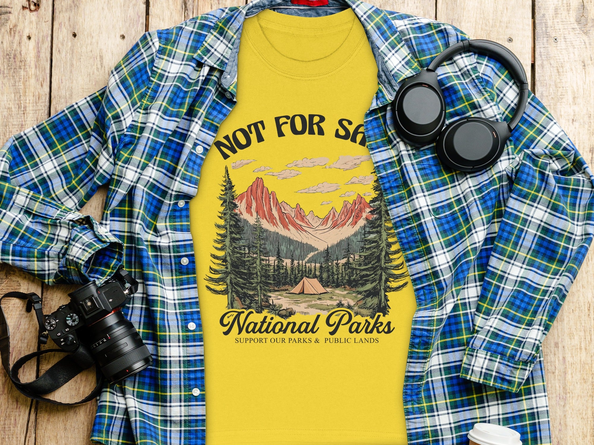 Yellow t-shirt with "NOT FOR SA National Parks" graphic and campfire scene.