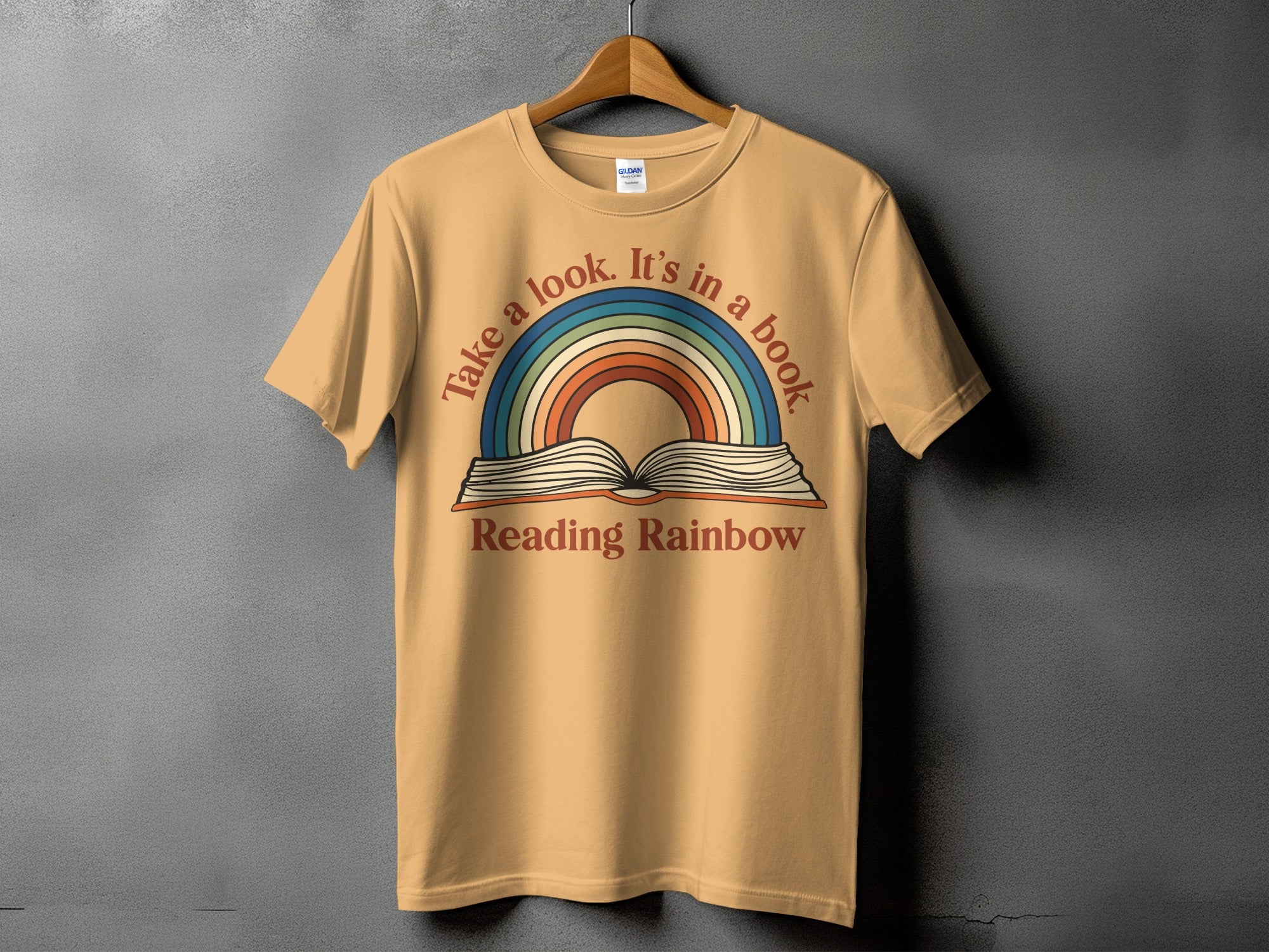 T-shirt with colorful rainbow and open book graphic and text "Reading Rainbow".