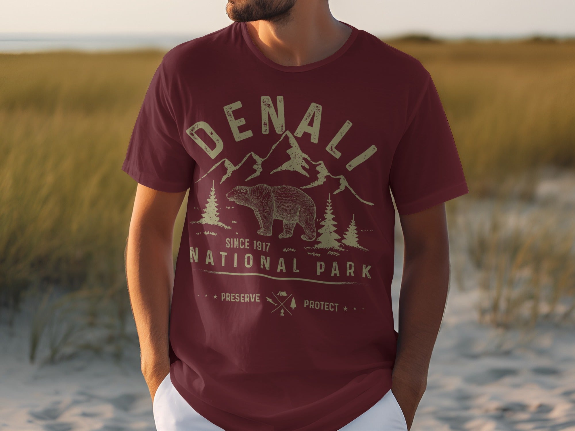 Maroon t-shirt with Denali National Park graphic, bear, mountains, trees, and text.