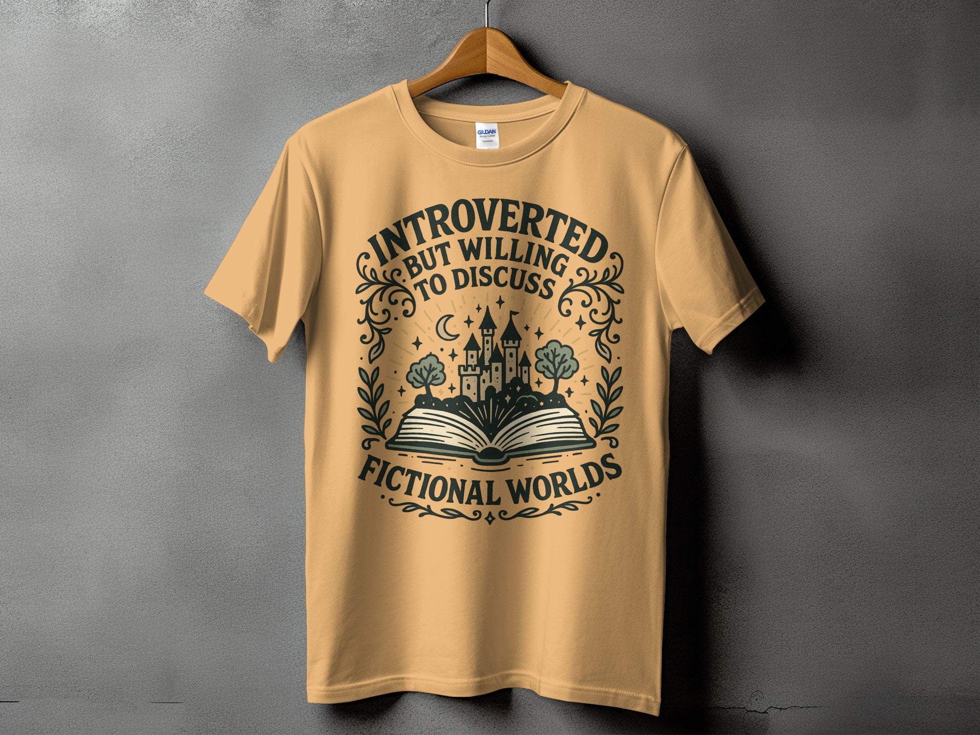 Peach t-shirt with "Introverted But Willing to Discuss Fictional Worlds" text and castle graphic.