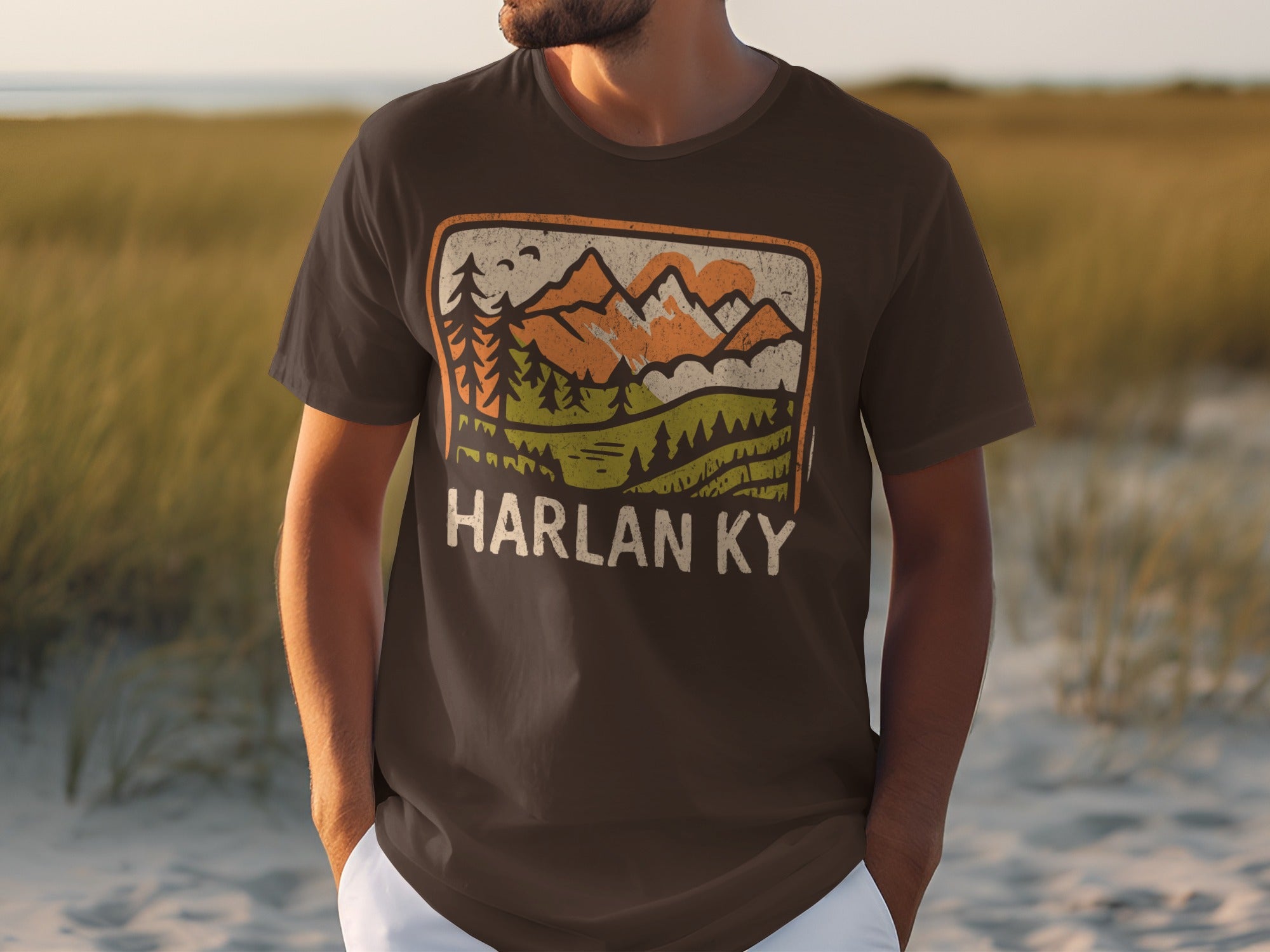 Brown t-shirt with vintage mountain landscape graphic and "HARLAN KY" text.