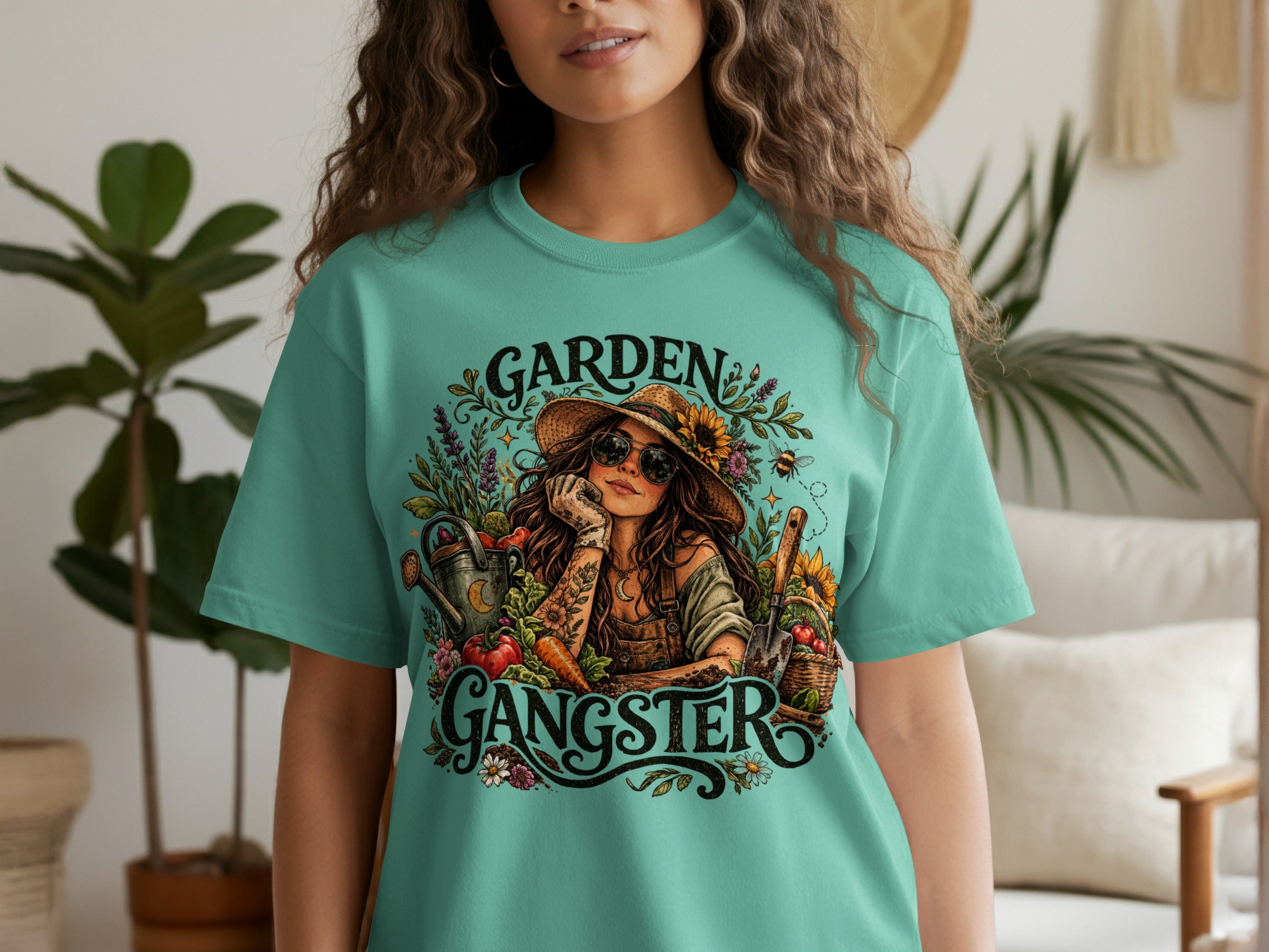 Teal graphic tee with "Garden Gangster" text and gardening imagery.
