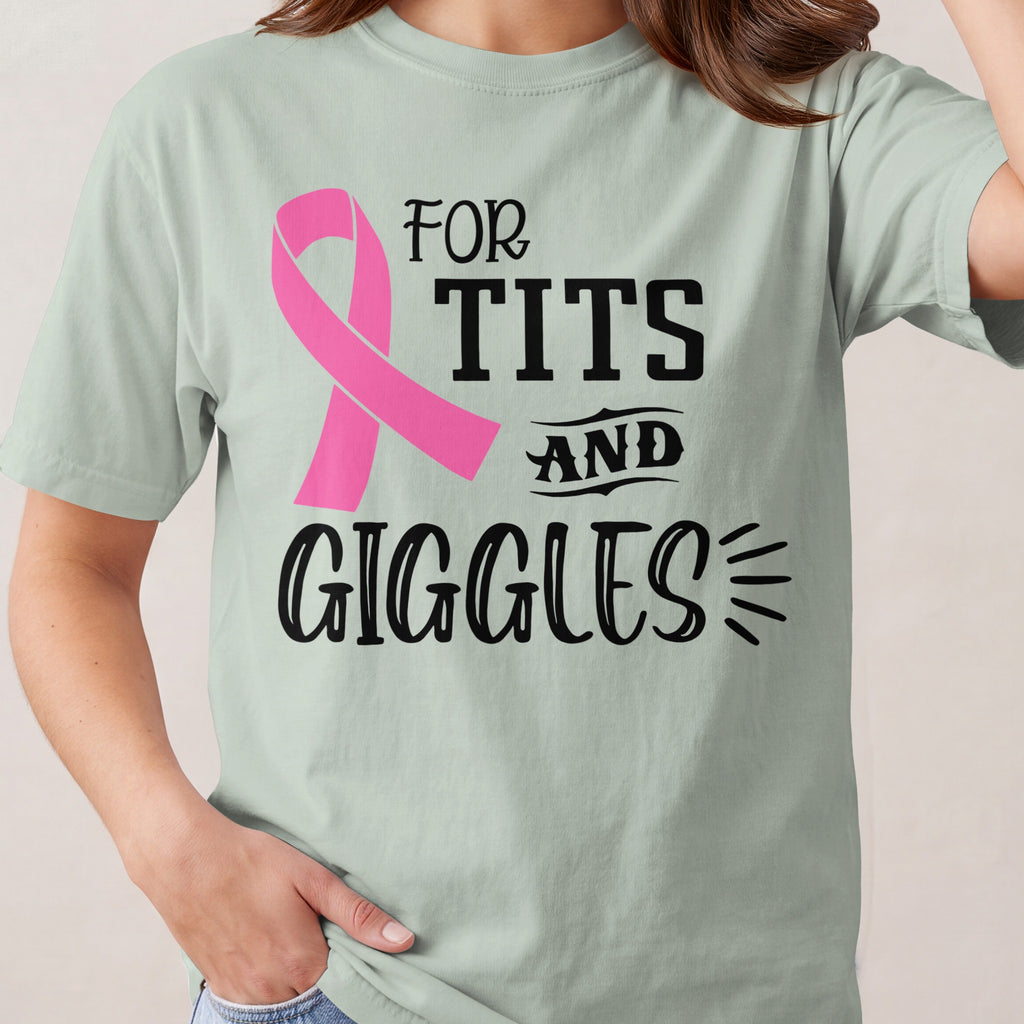Light green t-shirt with a pink ribbon and text reading "FOR TITS AND GIGGLES".