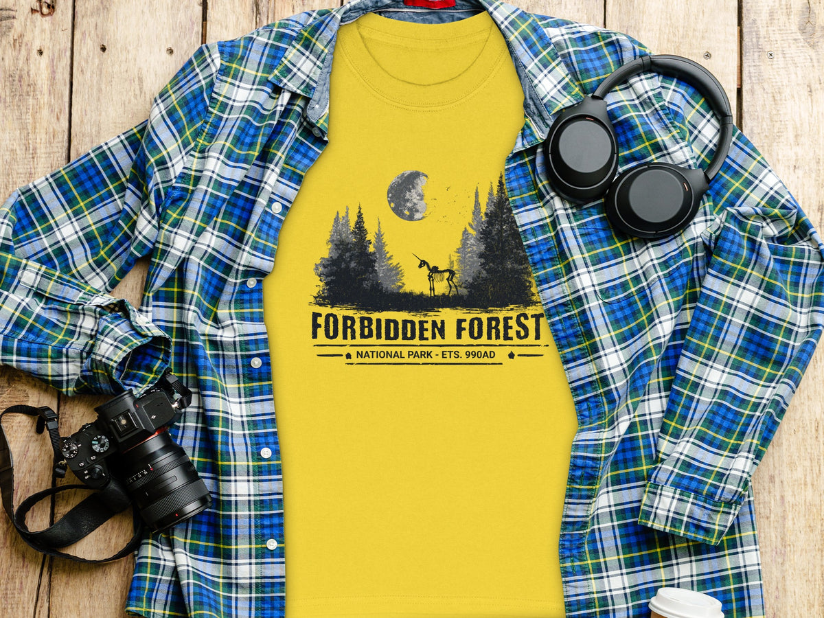 Yellow t-shirt with "Forbidden Forest National Park" graphic and a skeleton unicorn.