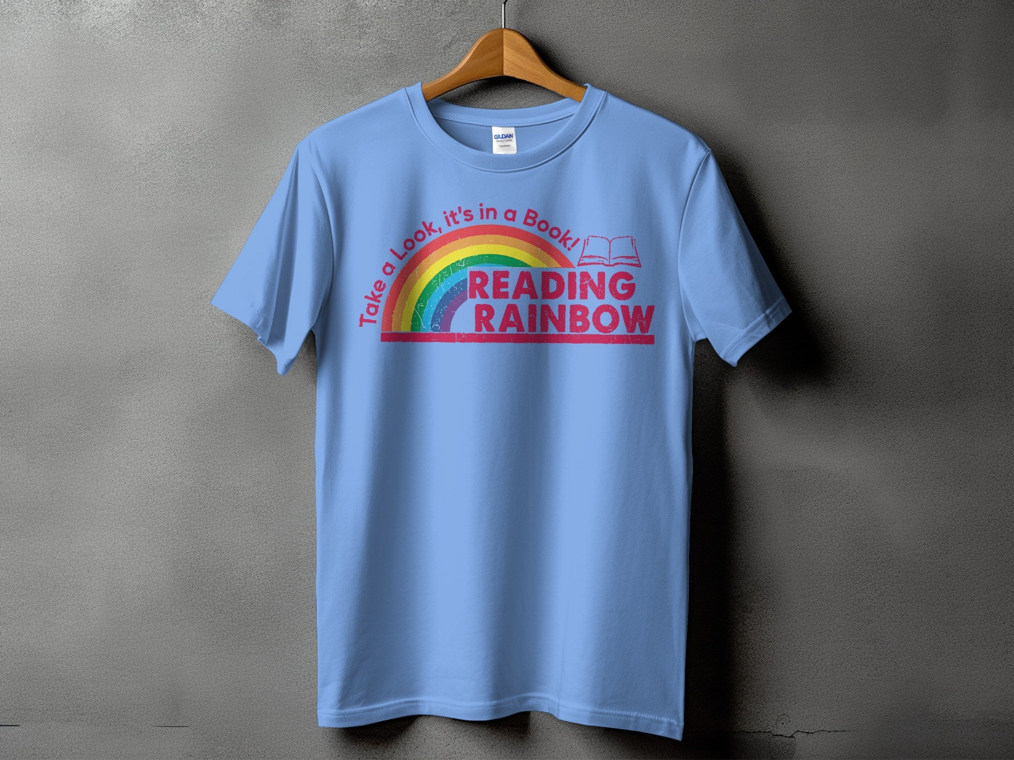 Light blue t-shirt with "Reading Rainbow" text and a rainbow graphic.