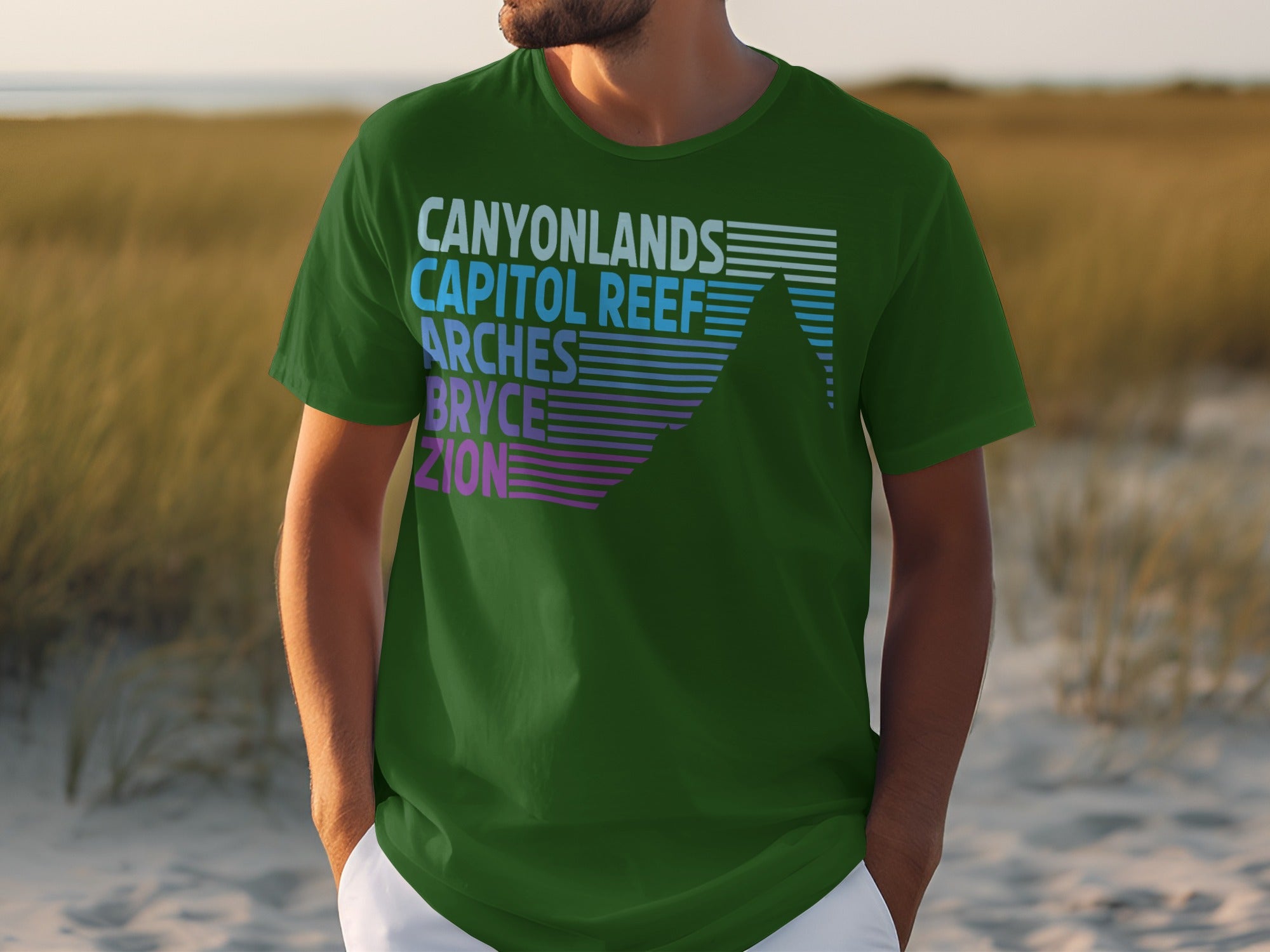 Green t-shirt with text listing national parks and a mountain graphic.