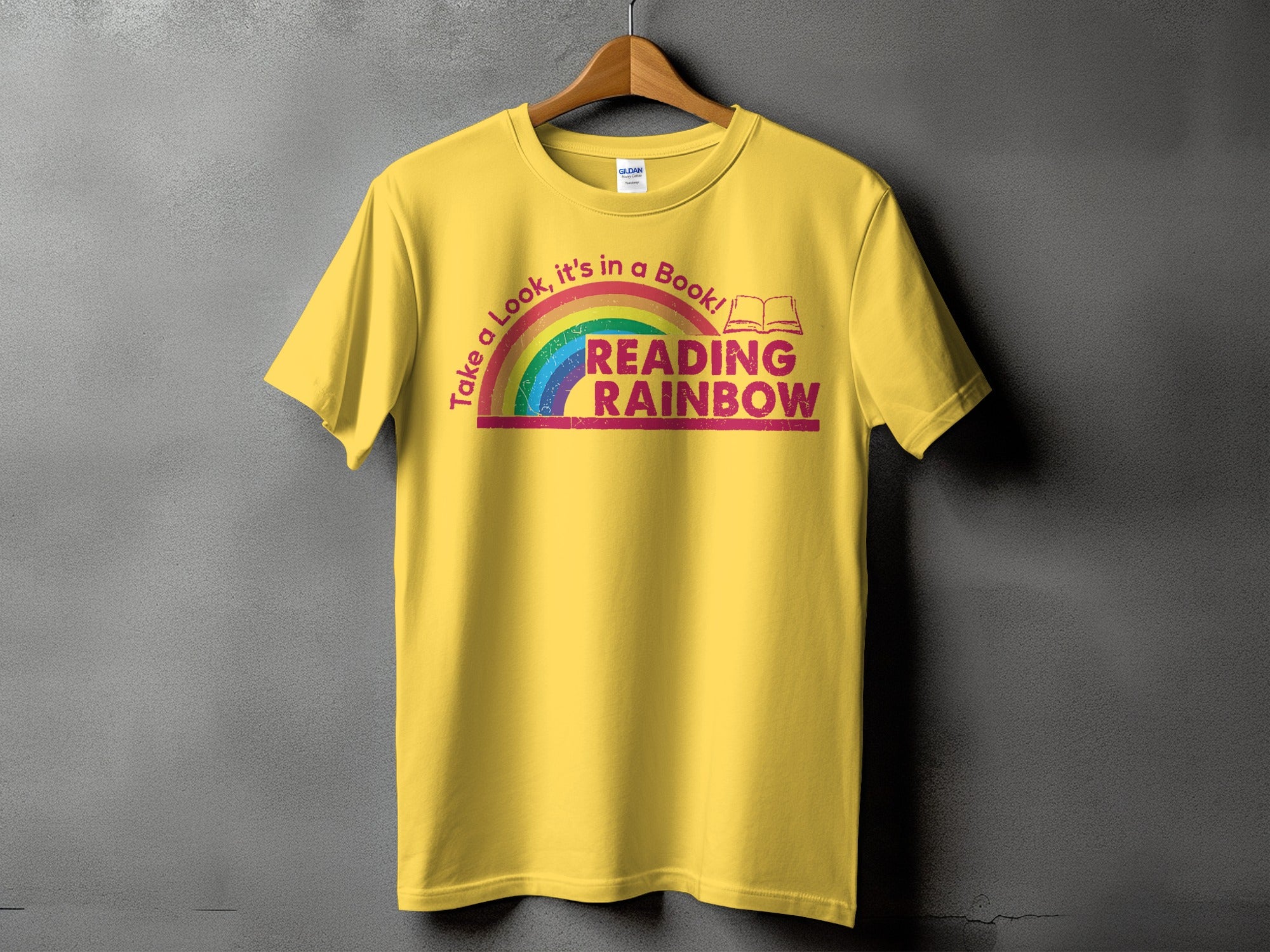 Yellow t-shirt with "Reading Rainbow" text and rainbow graphic.