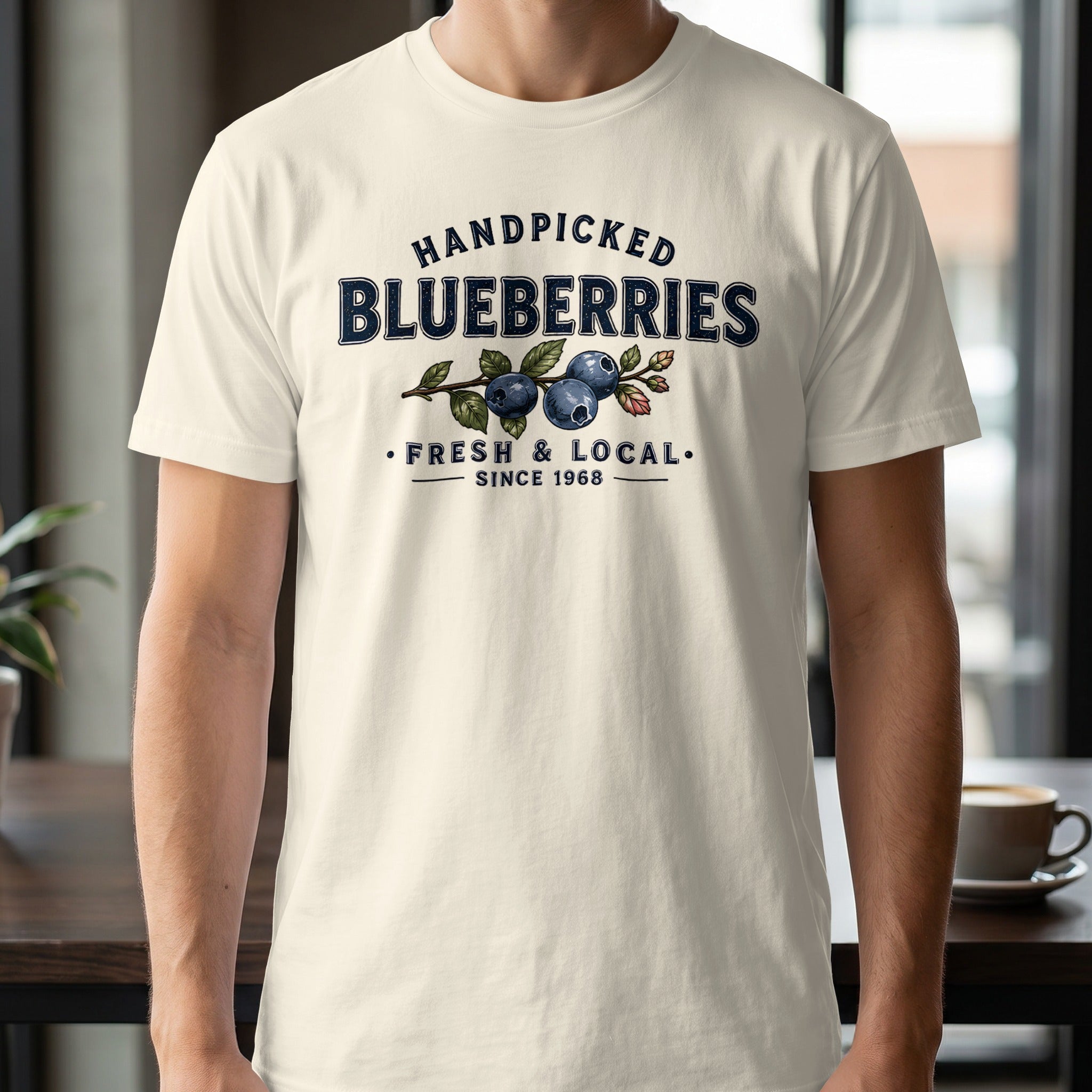 Cream t-shirt with "Handpicked Blueberries Fresh & Local Since 1968" text and blueberry graphic.