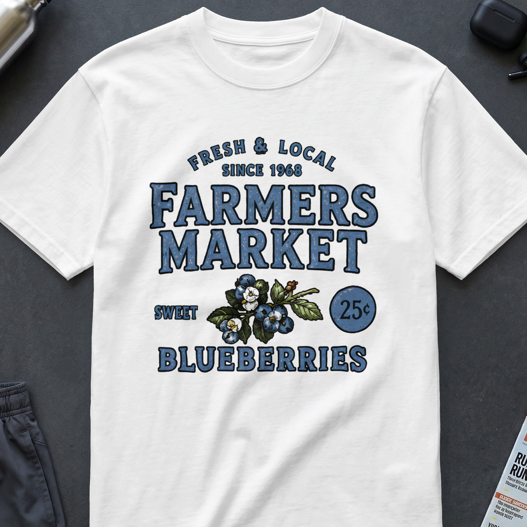White t-shirt with "Fresh & Local Farmers Market" and blueberries graphic.