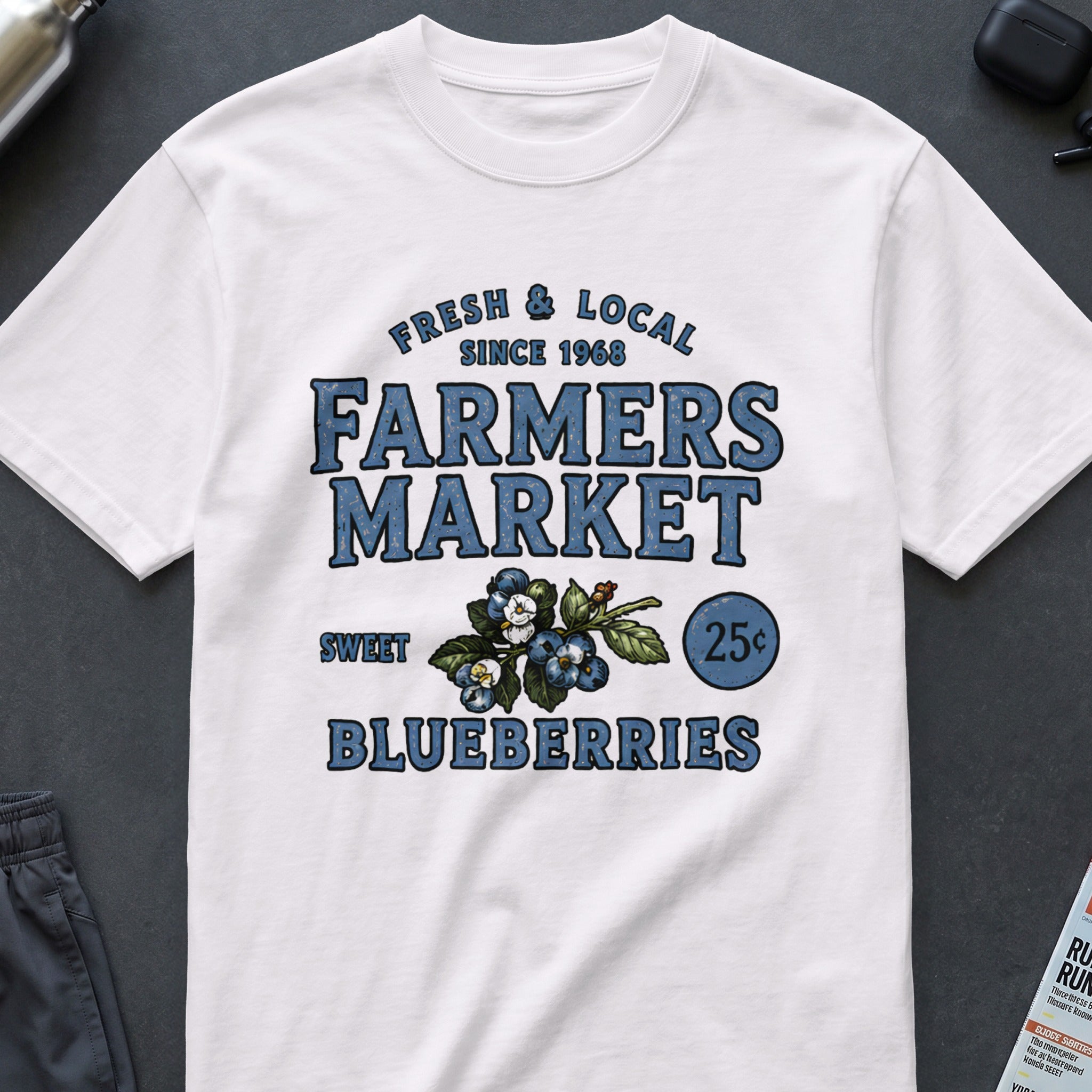 White t-shirt with "Fresh & Local Farmers Market" and blueberries graphic.