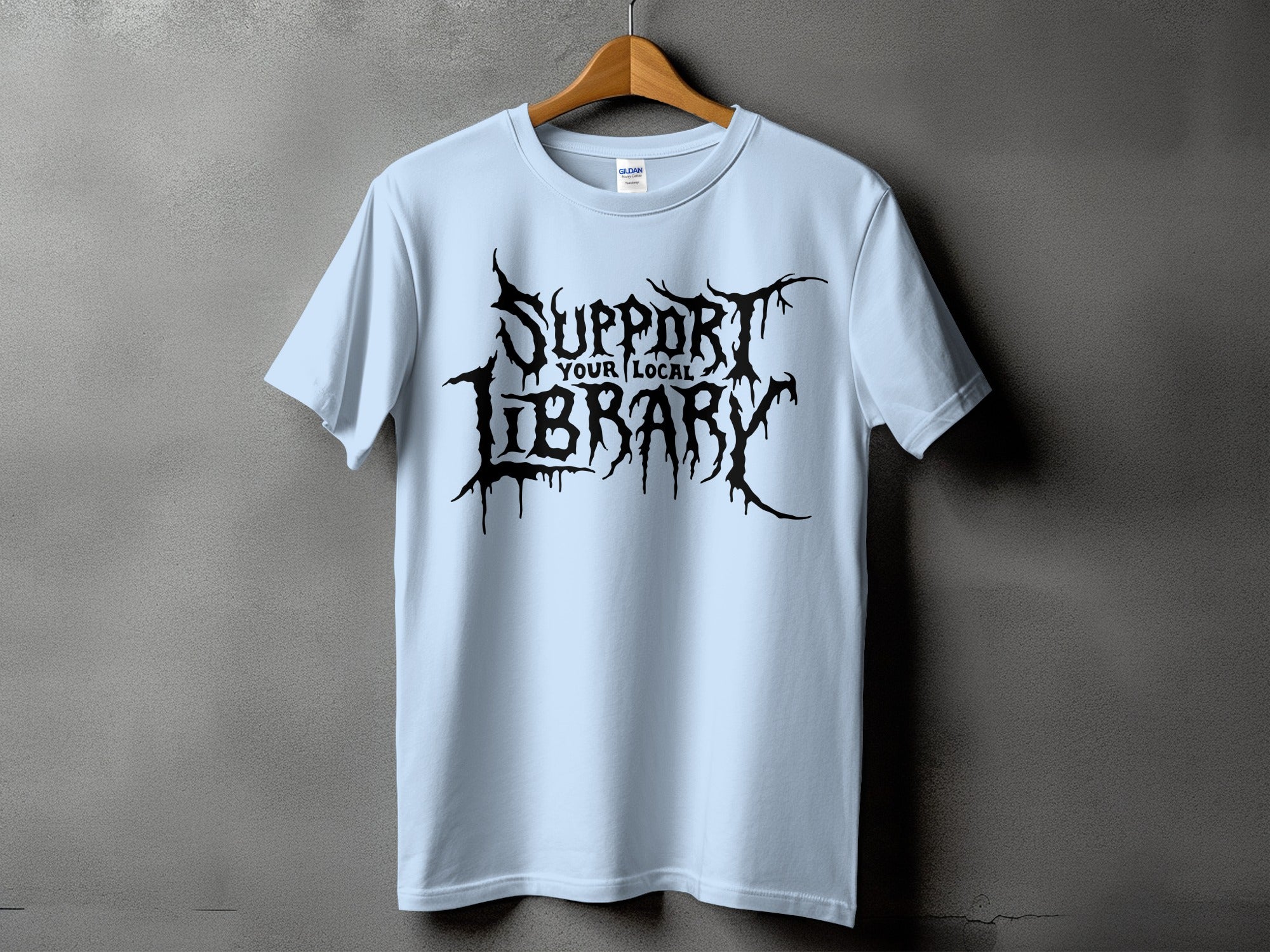 Light blue t-shirt with black drippy font text "SUPPORT YOUR LOCAL LIBRARY".