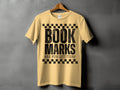 Yellow t-shirt with black text reading "BOOK MARKS ARE FOR QUITTERS".