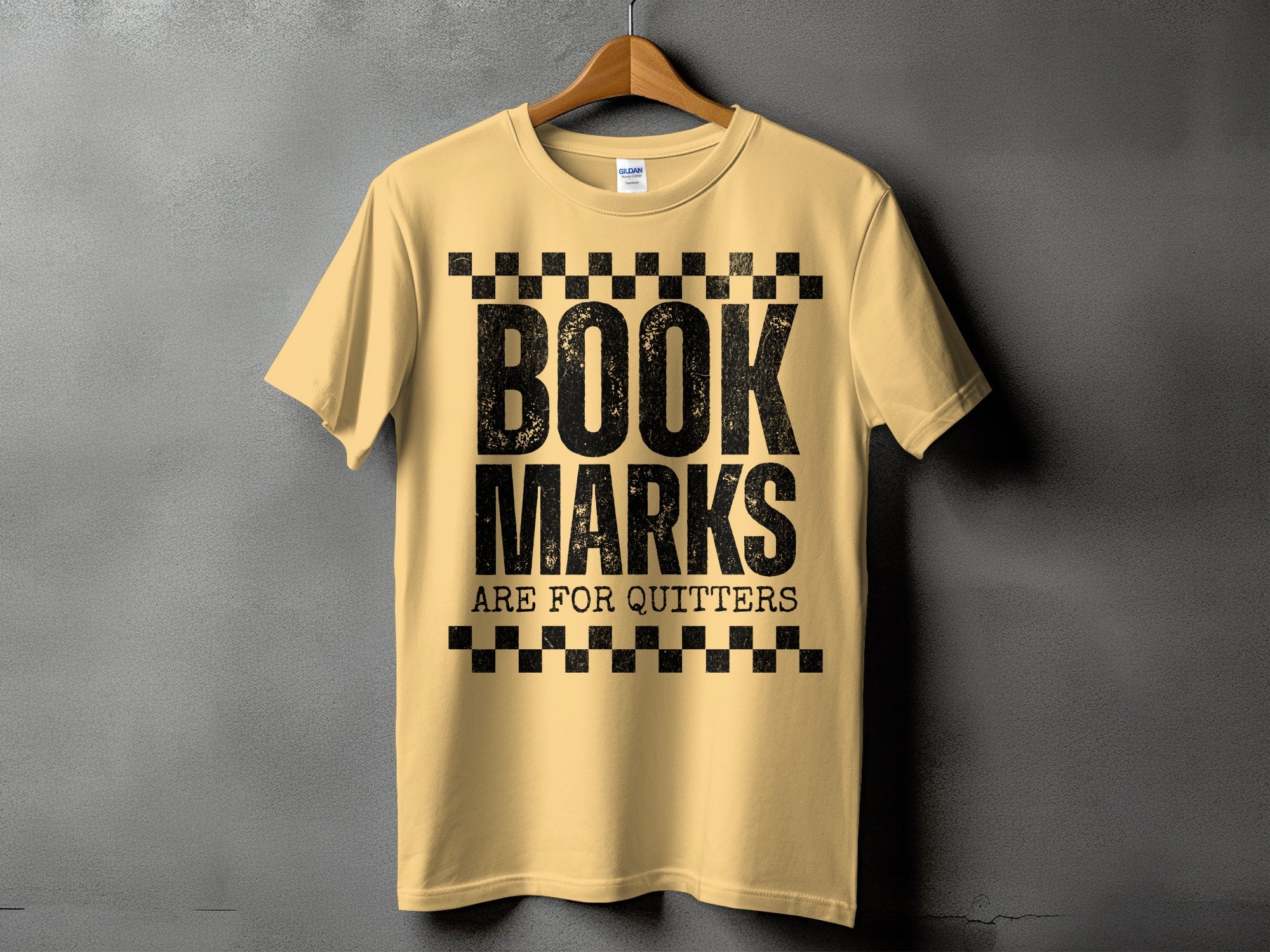 Yellow t-shirt with black text reading "BOOK MARKS ARE FOR QUITTERS".