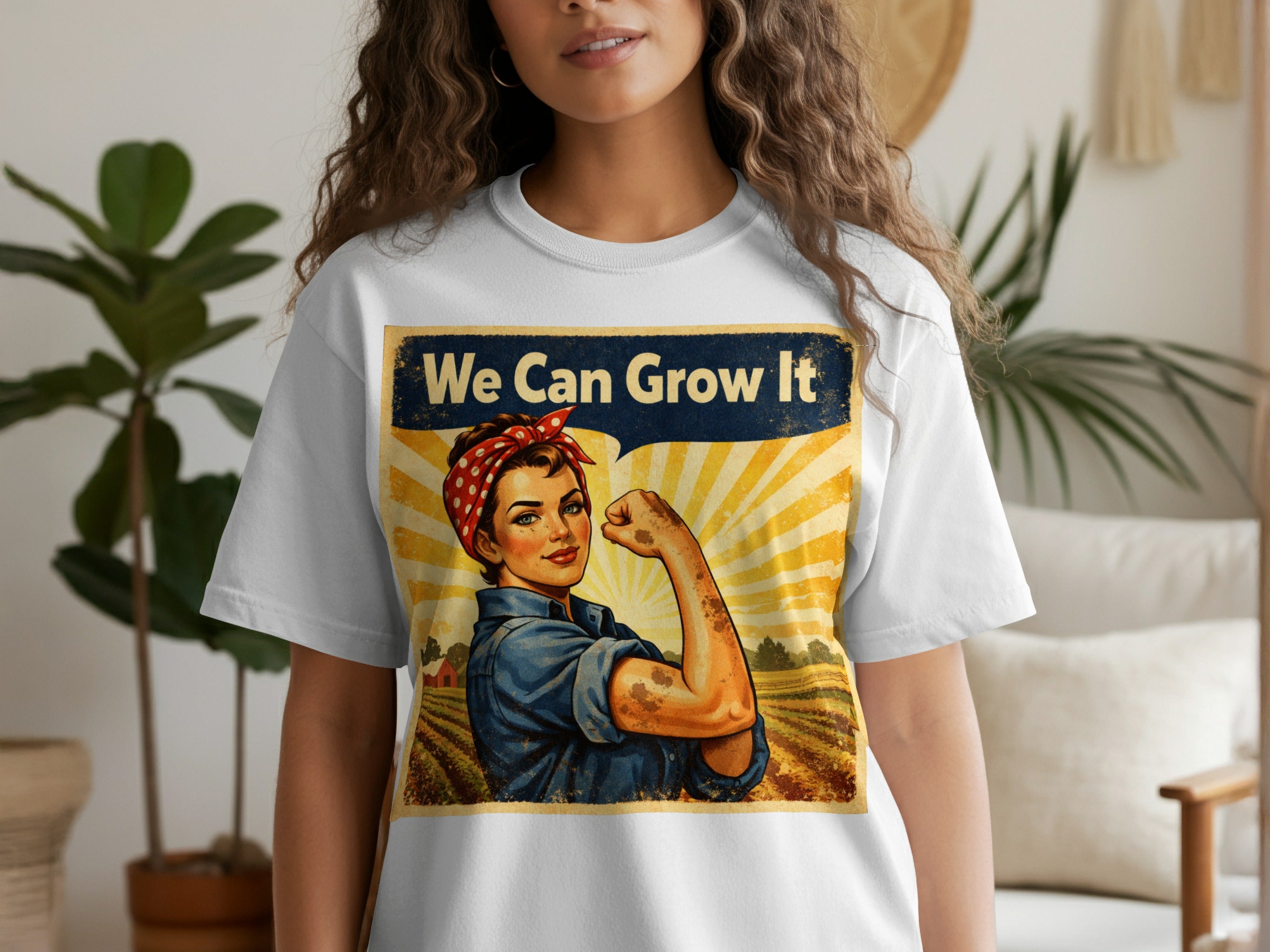 T-shirt with "We Can Grow It" slogan featuring a woman flexing her arm in a field