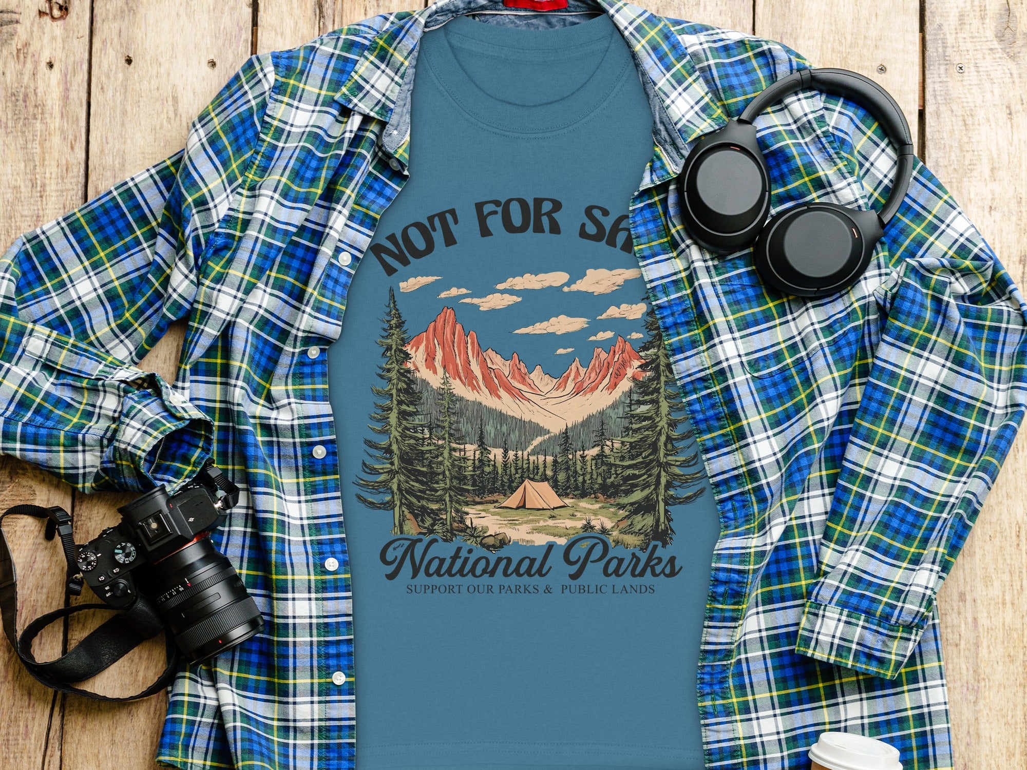 Blue T-shirt with mountain and tent graphic, "National Parks" text.