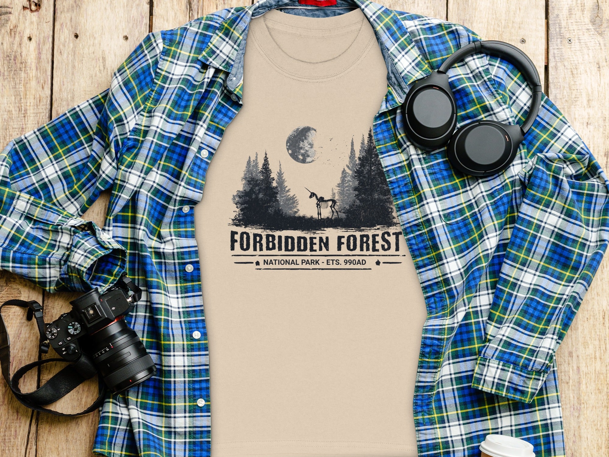 T-shirt with Forbidden Forest National Park text and skeleton unicorn graphic.