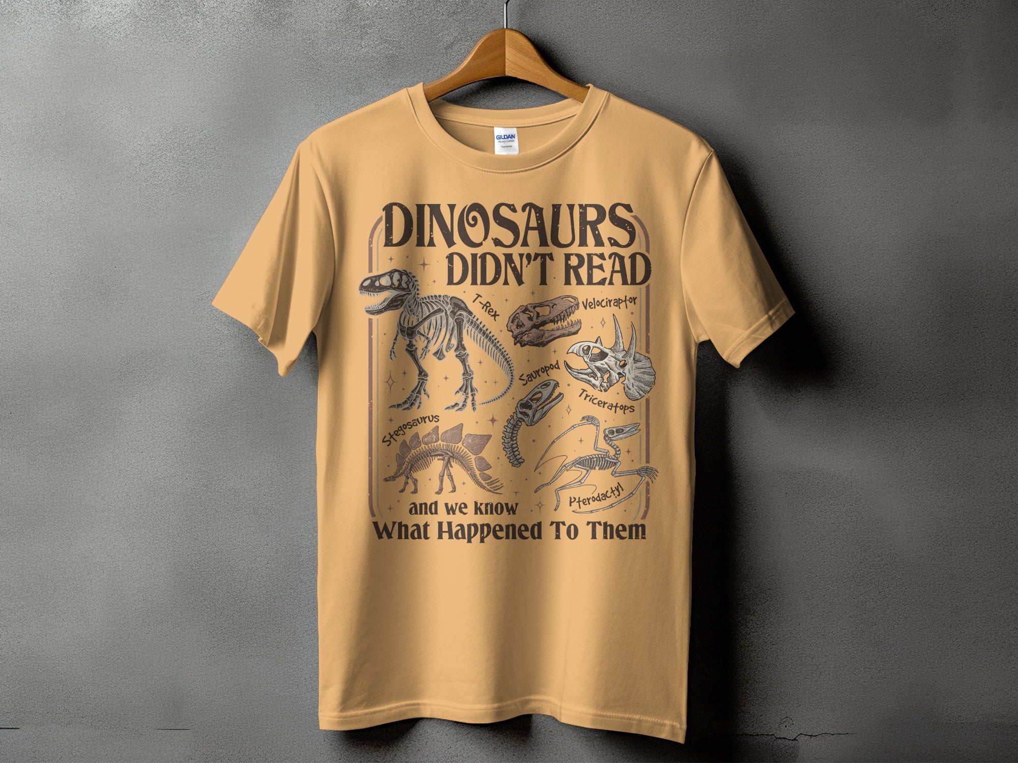 T-shirt with "Dinosaurs Didn't Read" text and dinosaur skeletons.